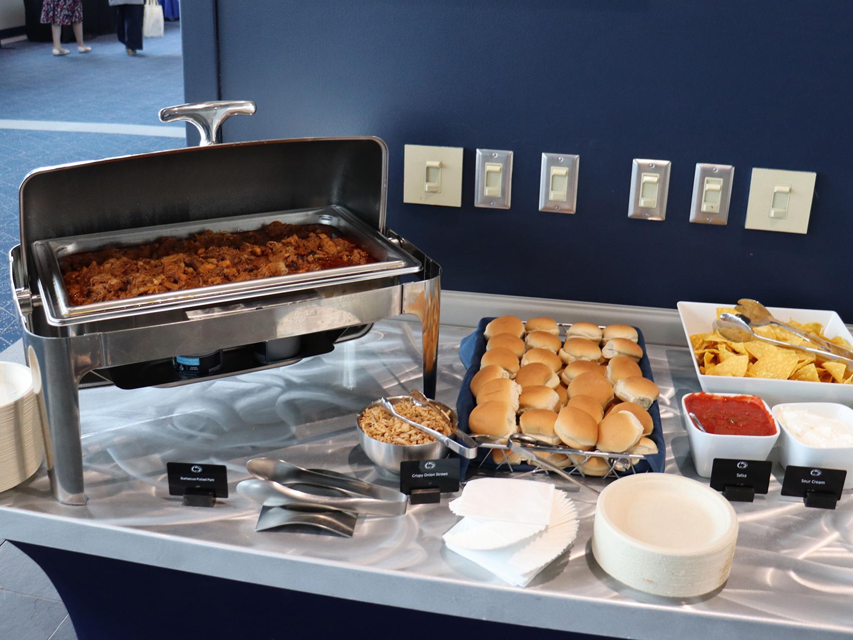 A table with a variety of foods served at a buffet.