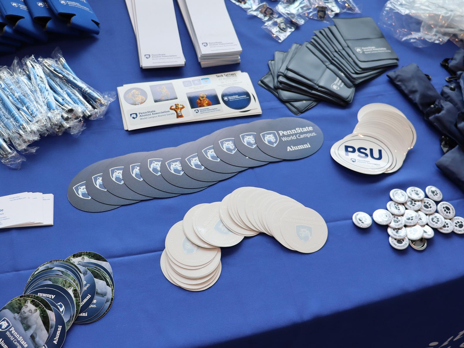 Free blue and white promotional items on a blue table.