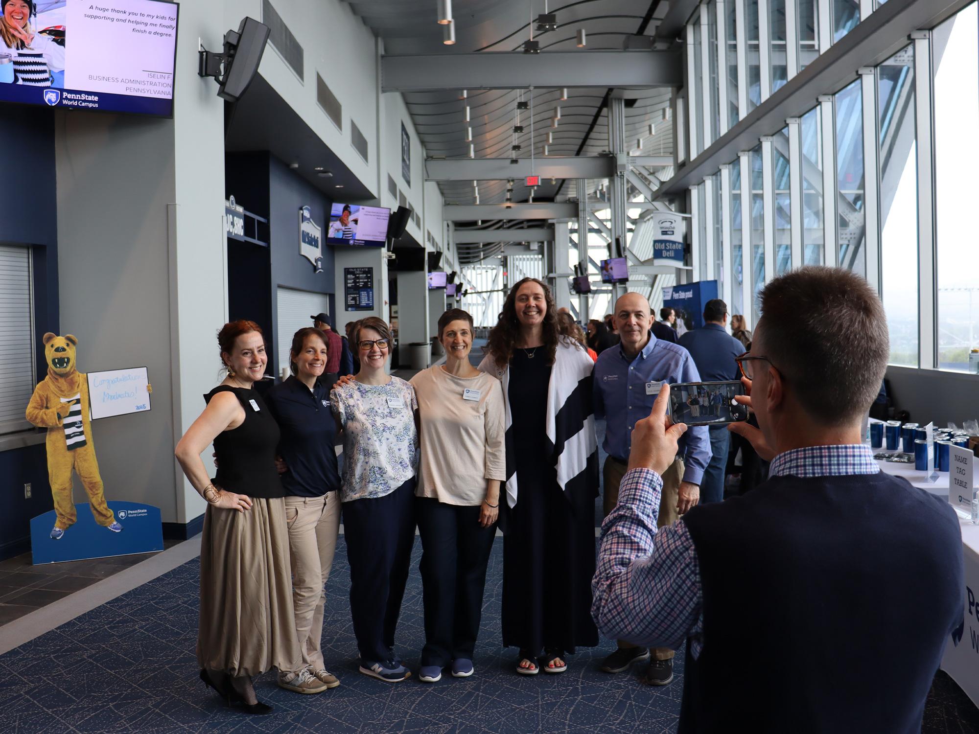 A man taking a photo of people in a lounge area.