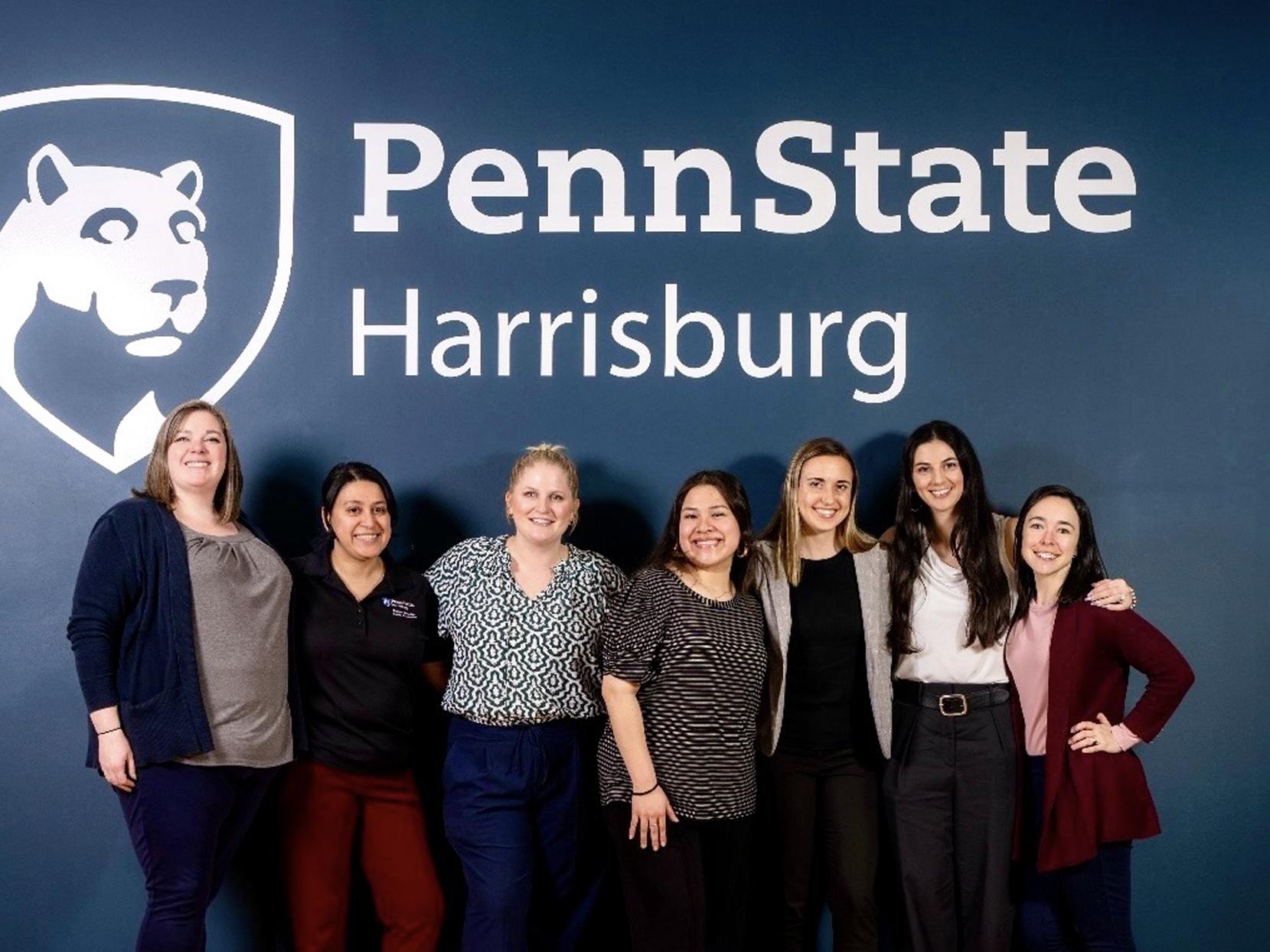 Jessica Barb poses with staff members at a Career Services event