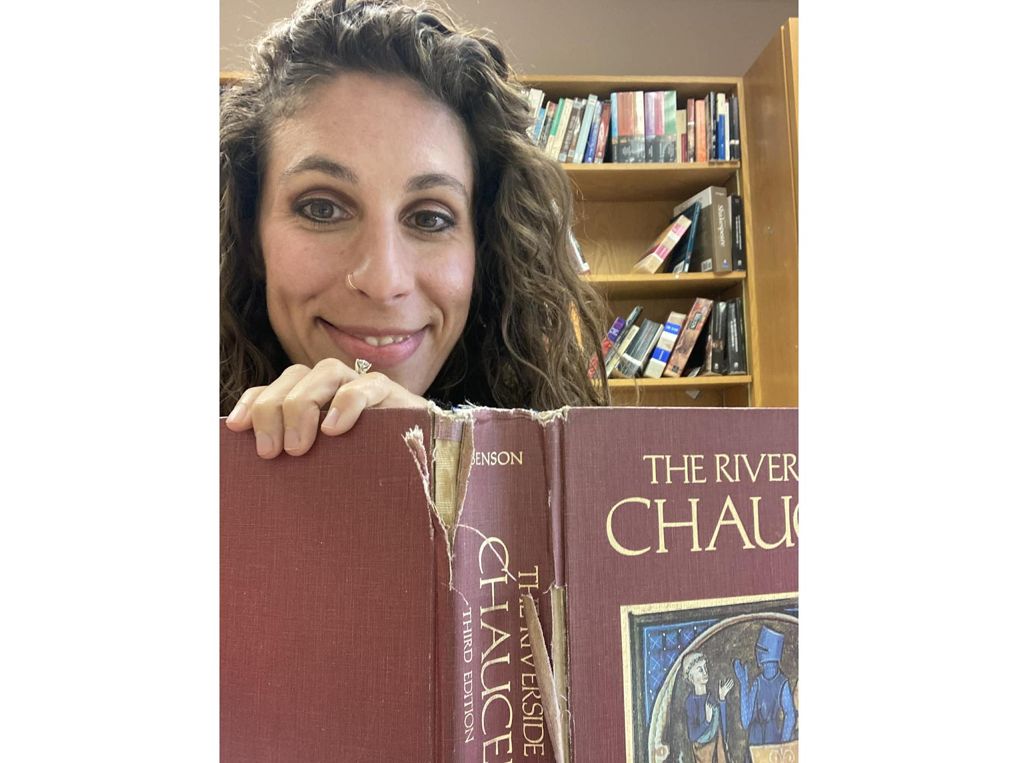 Leah Schwebel holding a copy of the Riverside Chaucer