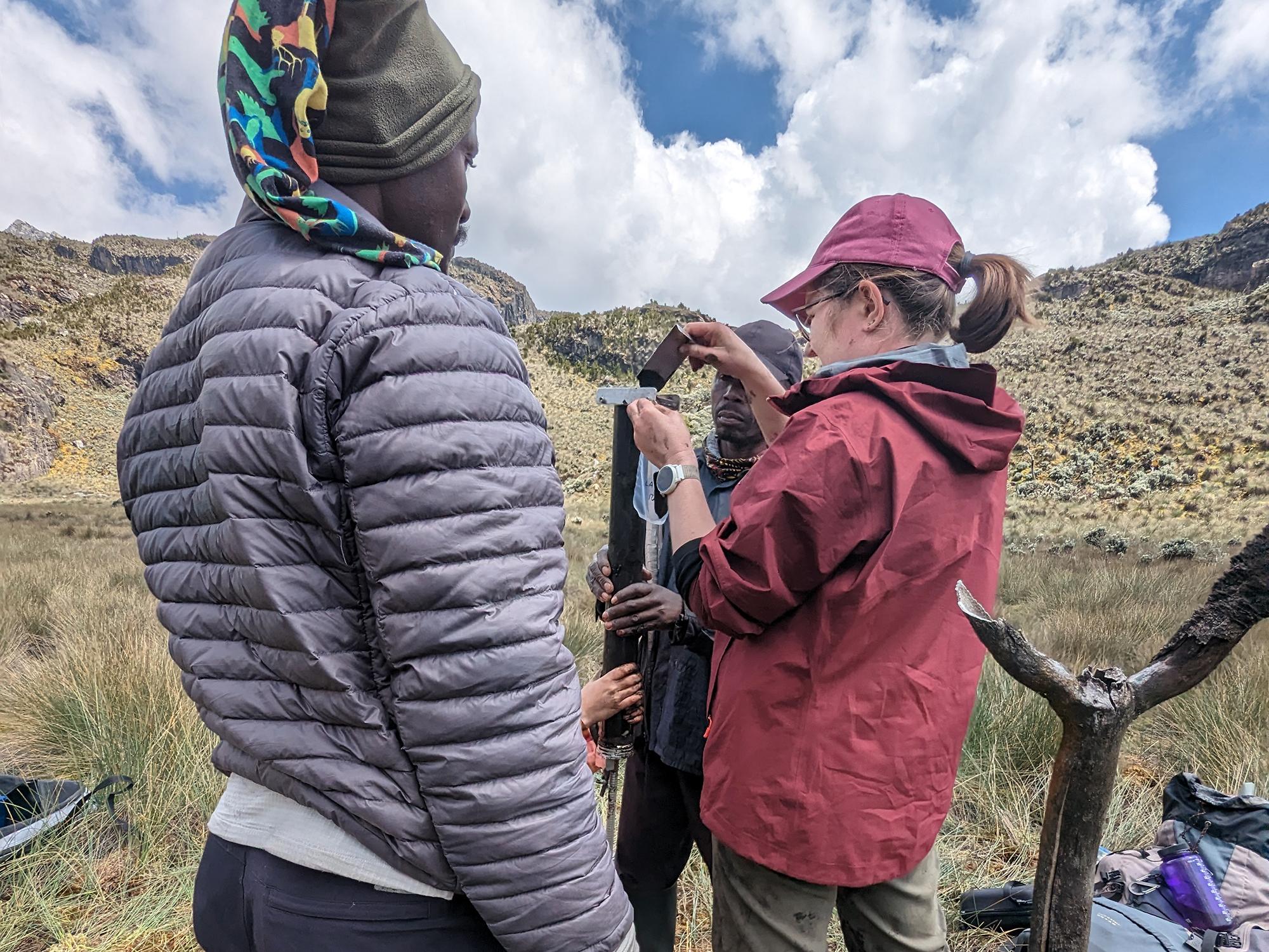 Meredith Parrish and Edson Kule subsample the sediment core