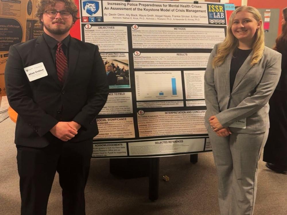 Allan Golden and Devlin Glenn stand in front of their research poster