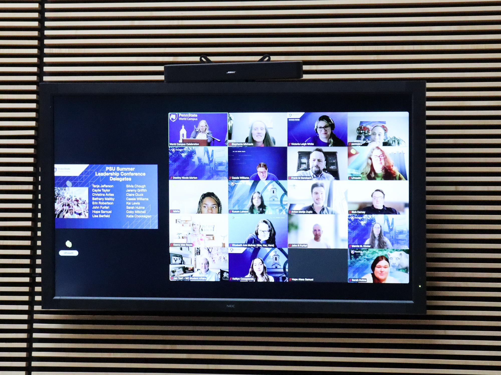 A TV screen showing a Zoom meeting.
