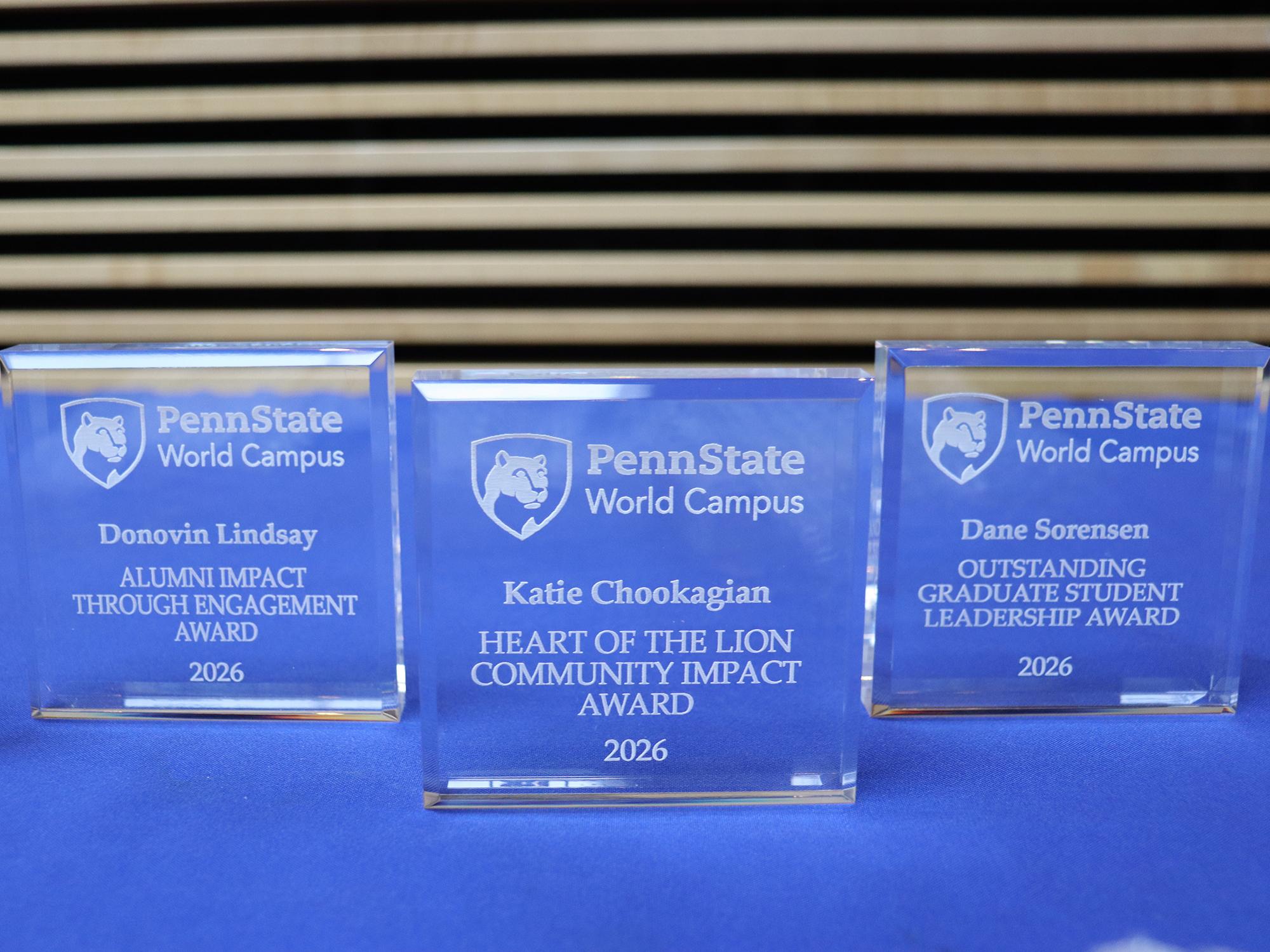 Crystal awards displayed on a blue table.