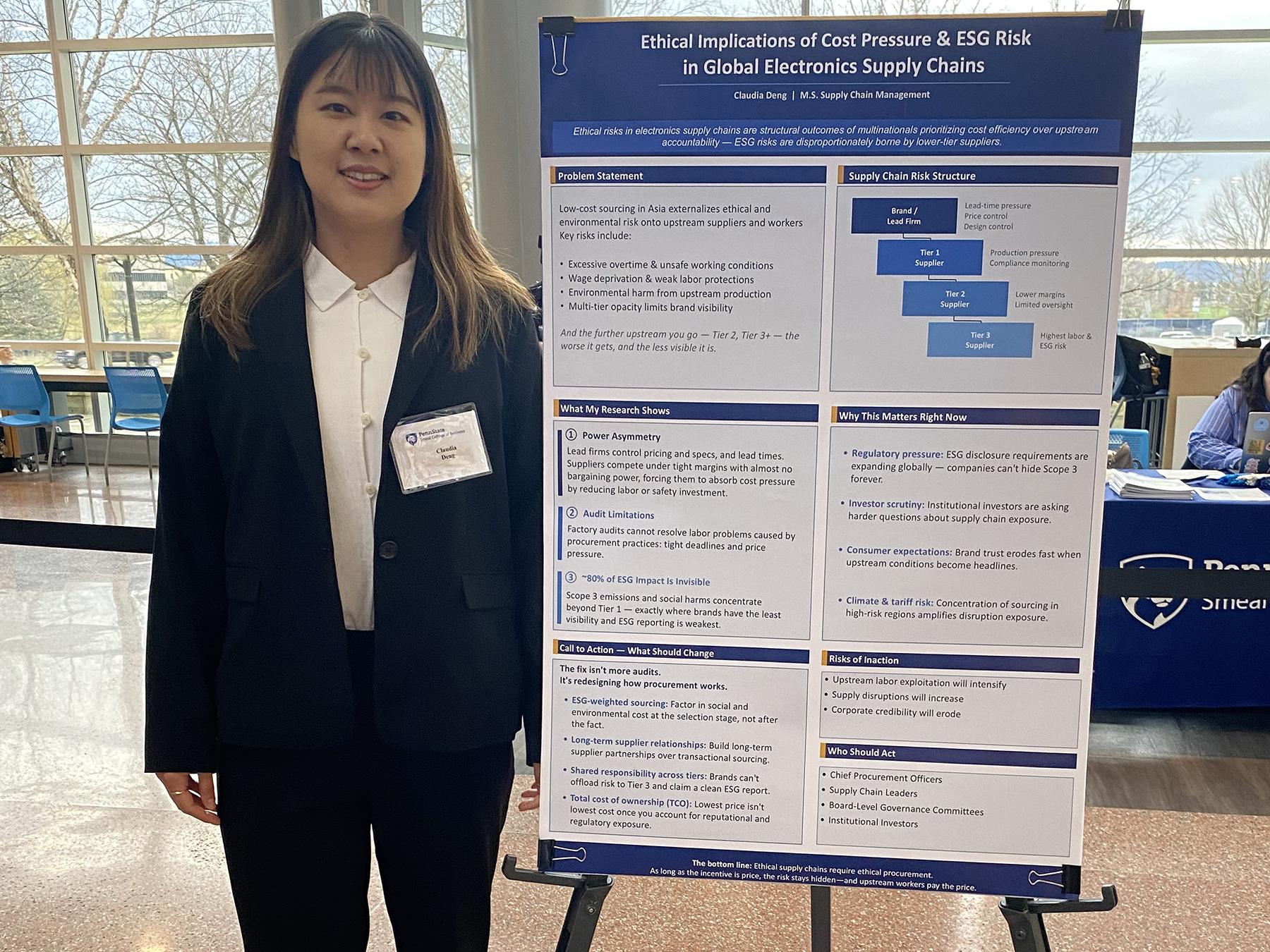 Claudia Deng stands next to her research poster.