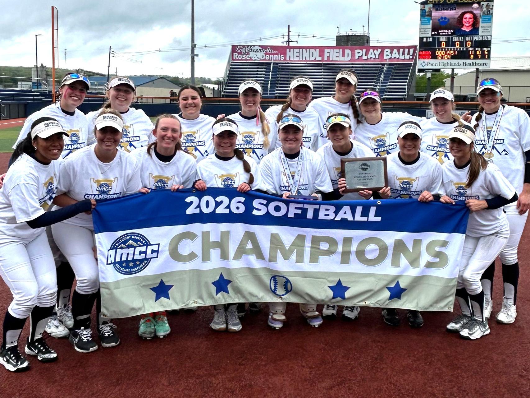 The Penn State Behrend softball team poses with the AMCC championship banner.