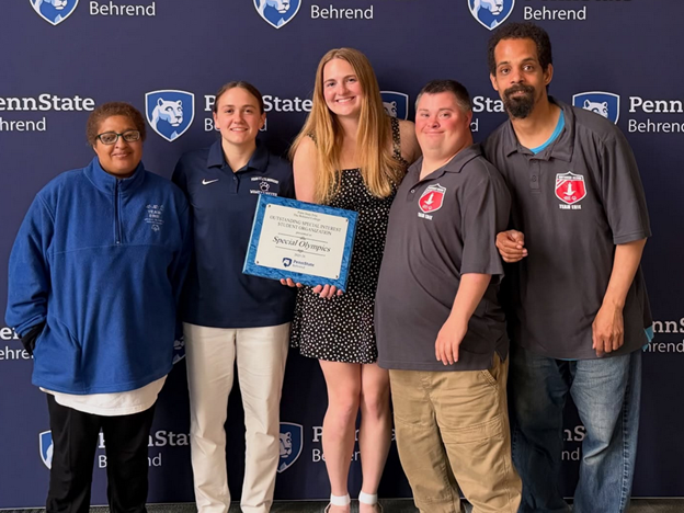 Penn State Behrend student-athletes pose with athletes from Special Olympics at an awards ceremony.