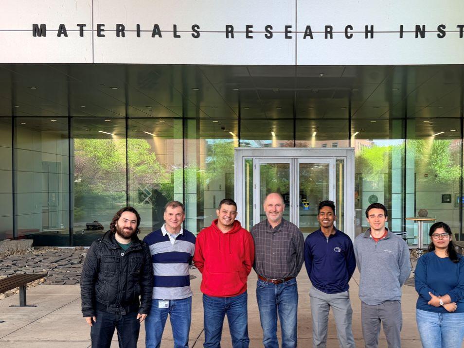 Group of people standing in front of the Materials Research Institute entrance