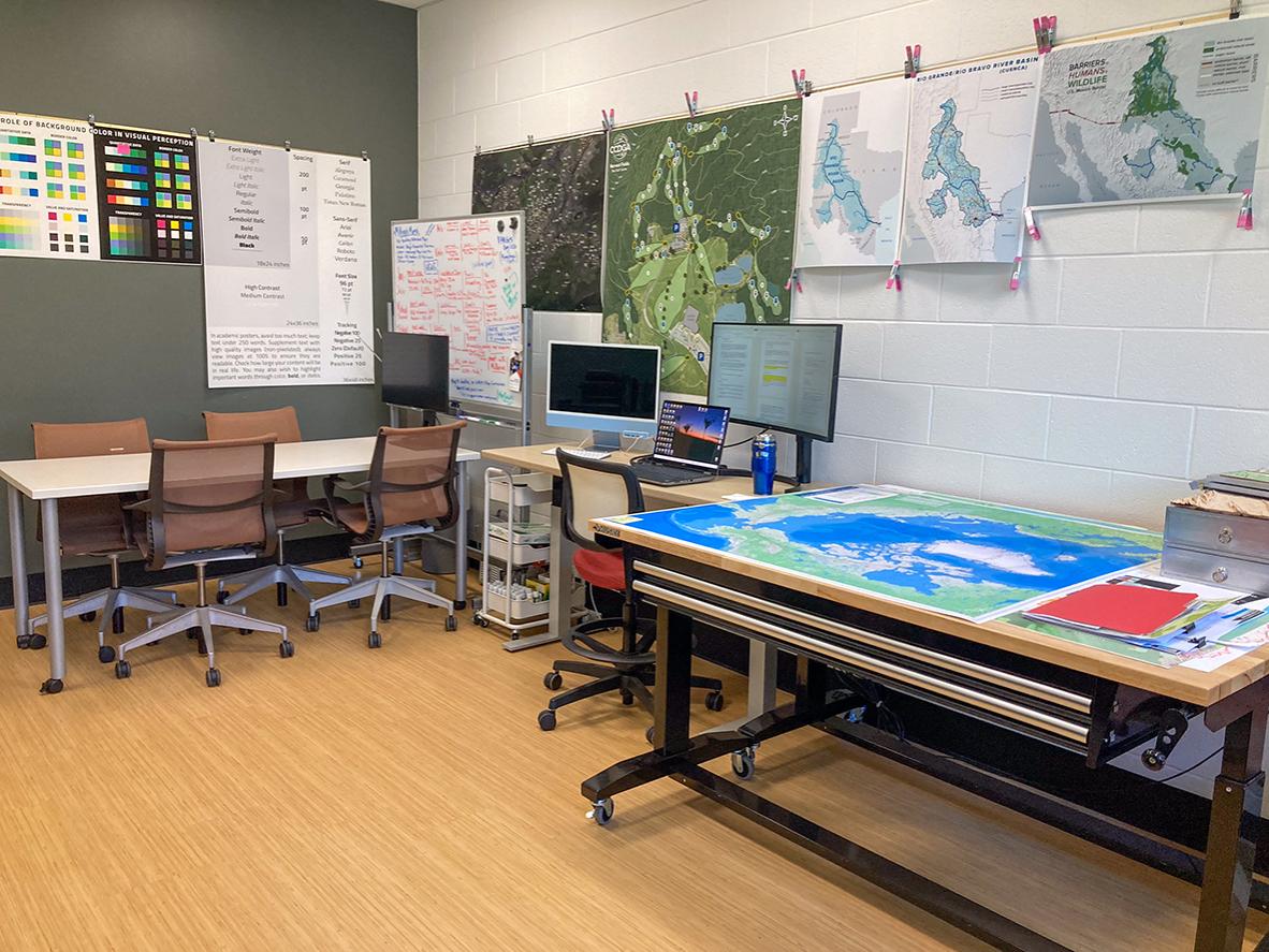 Workstations, maps and a large-format project table inside Penn State’s GeoGraphics Lab.