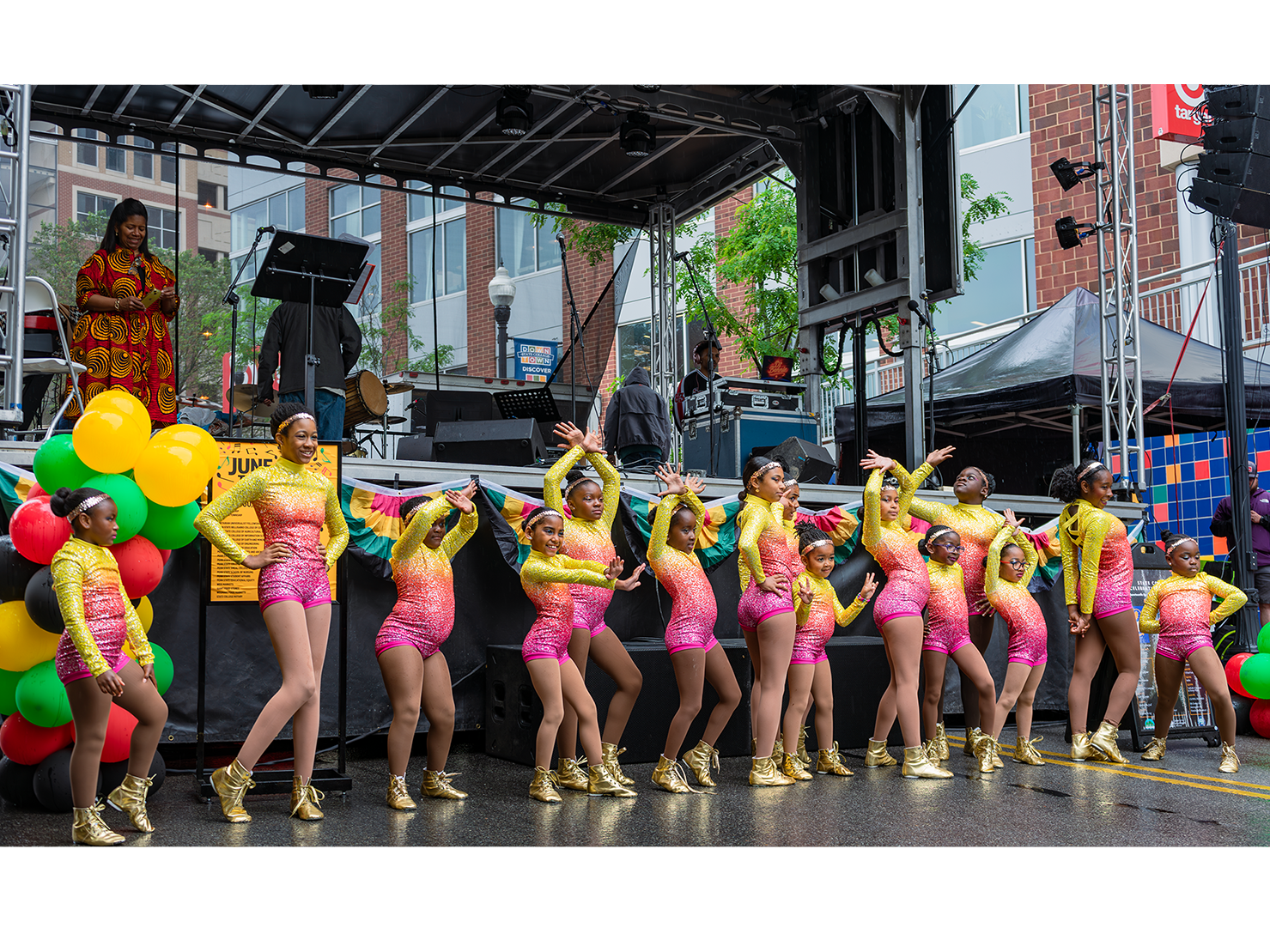 youth dancers wearing colorful costumes on stage