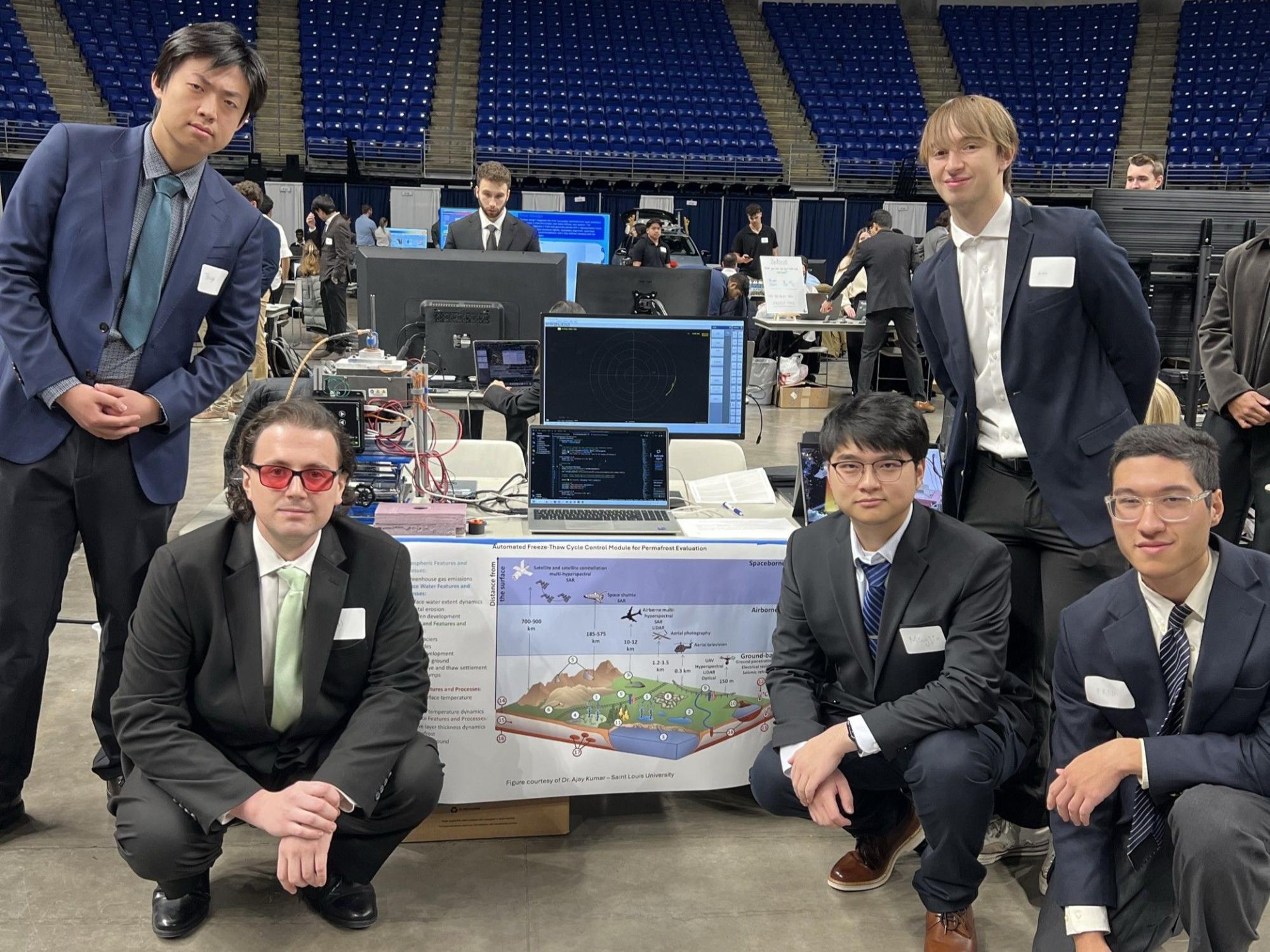 Group of people with their project at the Engineering Senior Capstone event. 