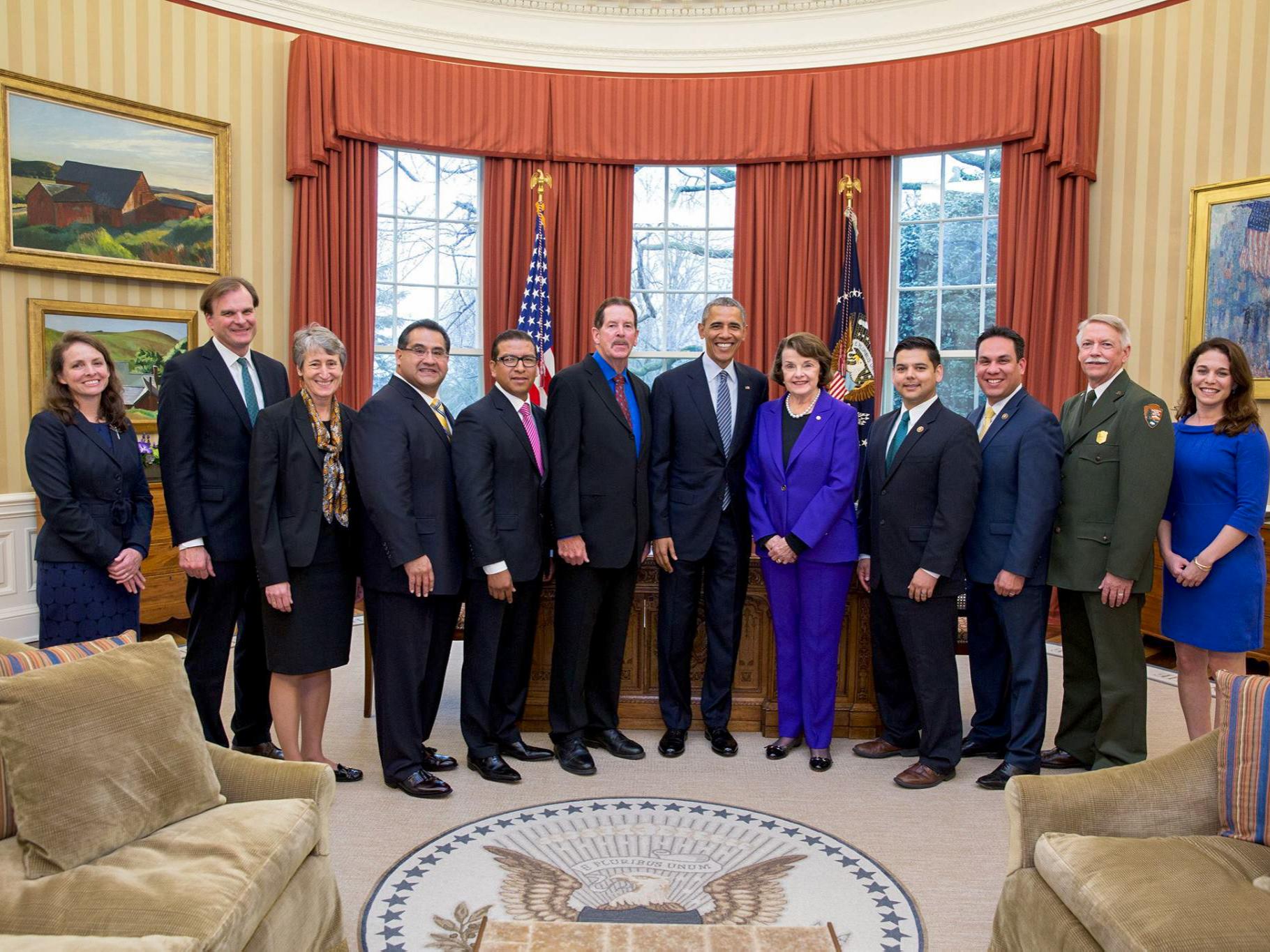 David Myers stands next to President Barack Obama and Senator Dianne Feinstein among others in the Oval Office of the White House.