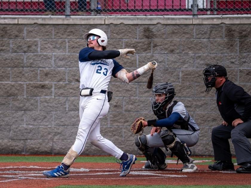 Baseball player hitting the ball.