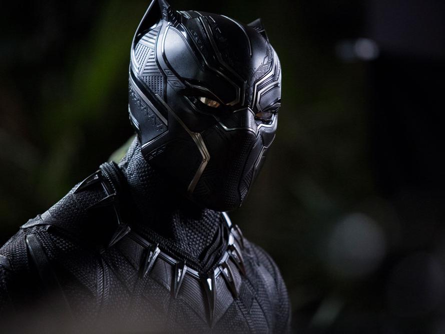 A superhero wears a panther-inspired protective body armor.