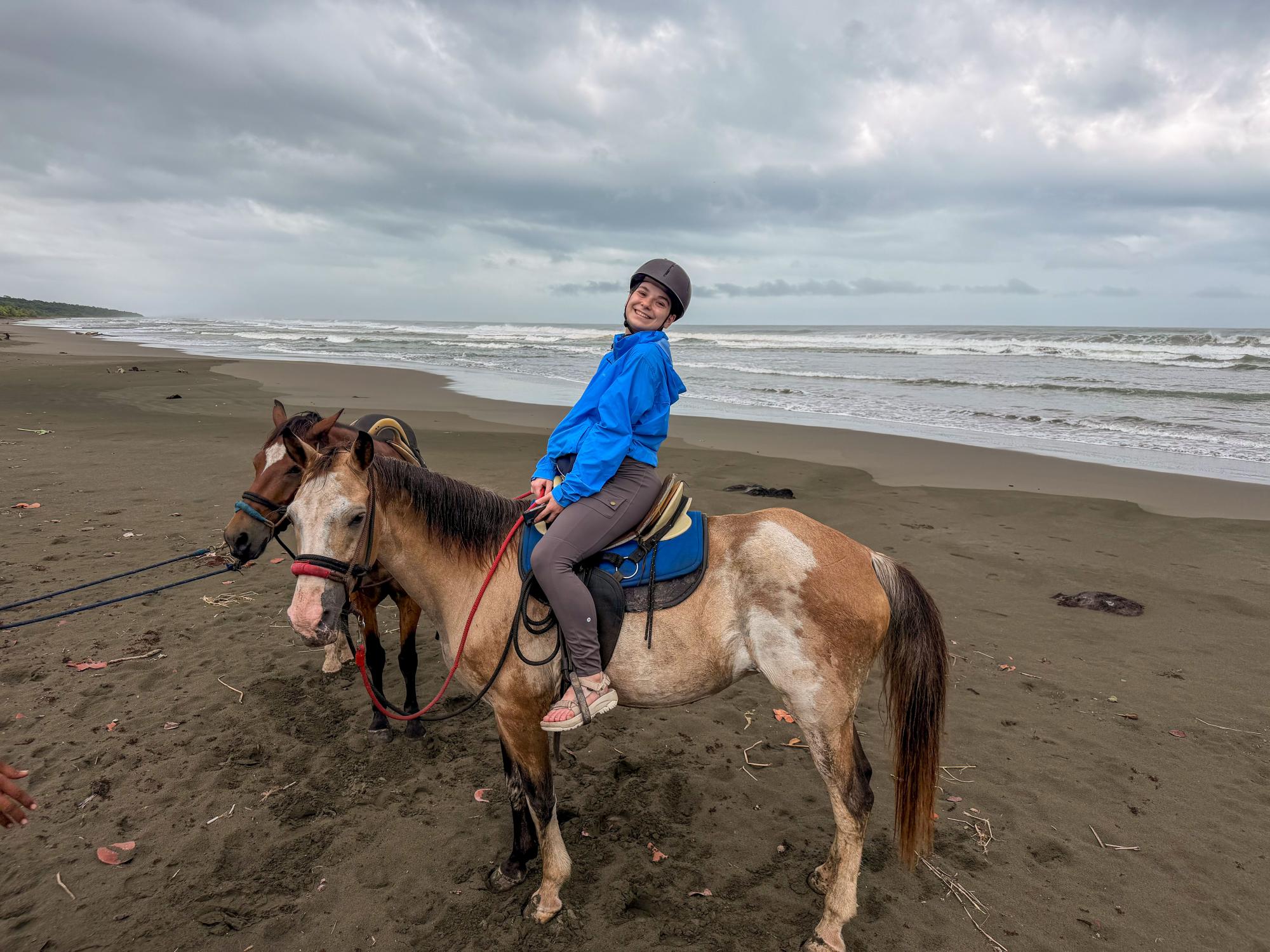 Student posing on a horse on a beach in Cahuita.