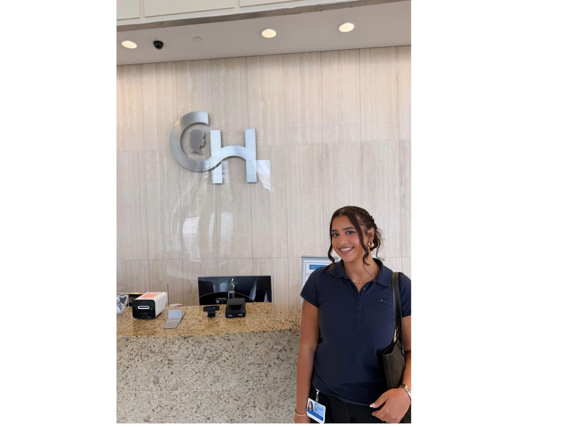 Smiling dark-haired worker at Children's Hospital