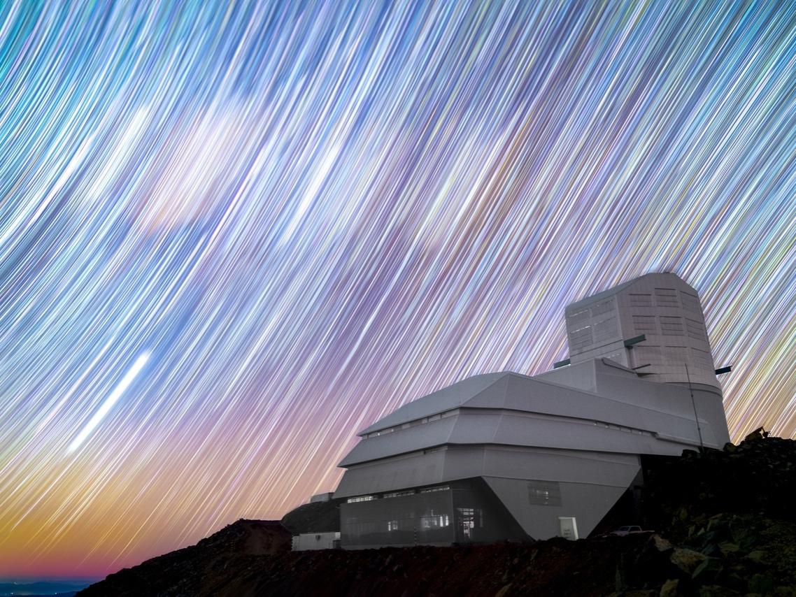 Vera Rubin Observatory with long exposure of stars tracing the sky.