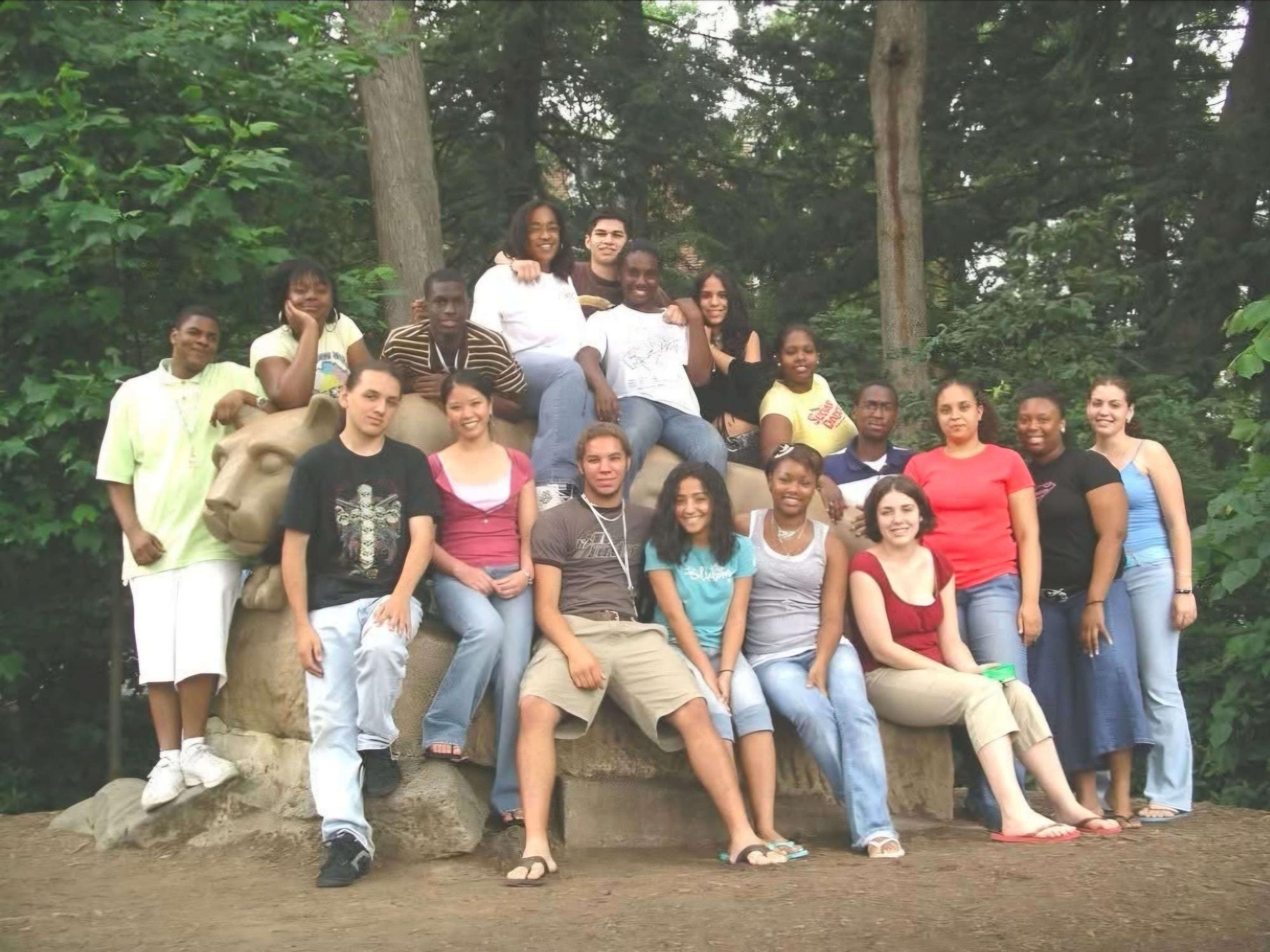 A group of students pose with the Nittany Lion Shrine