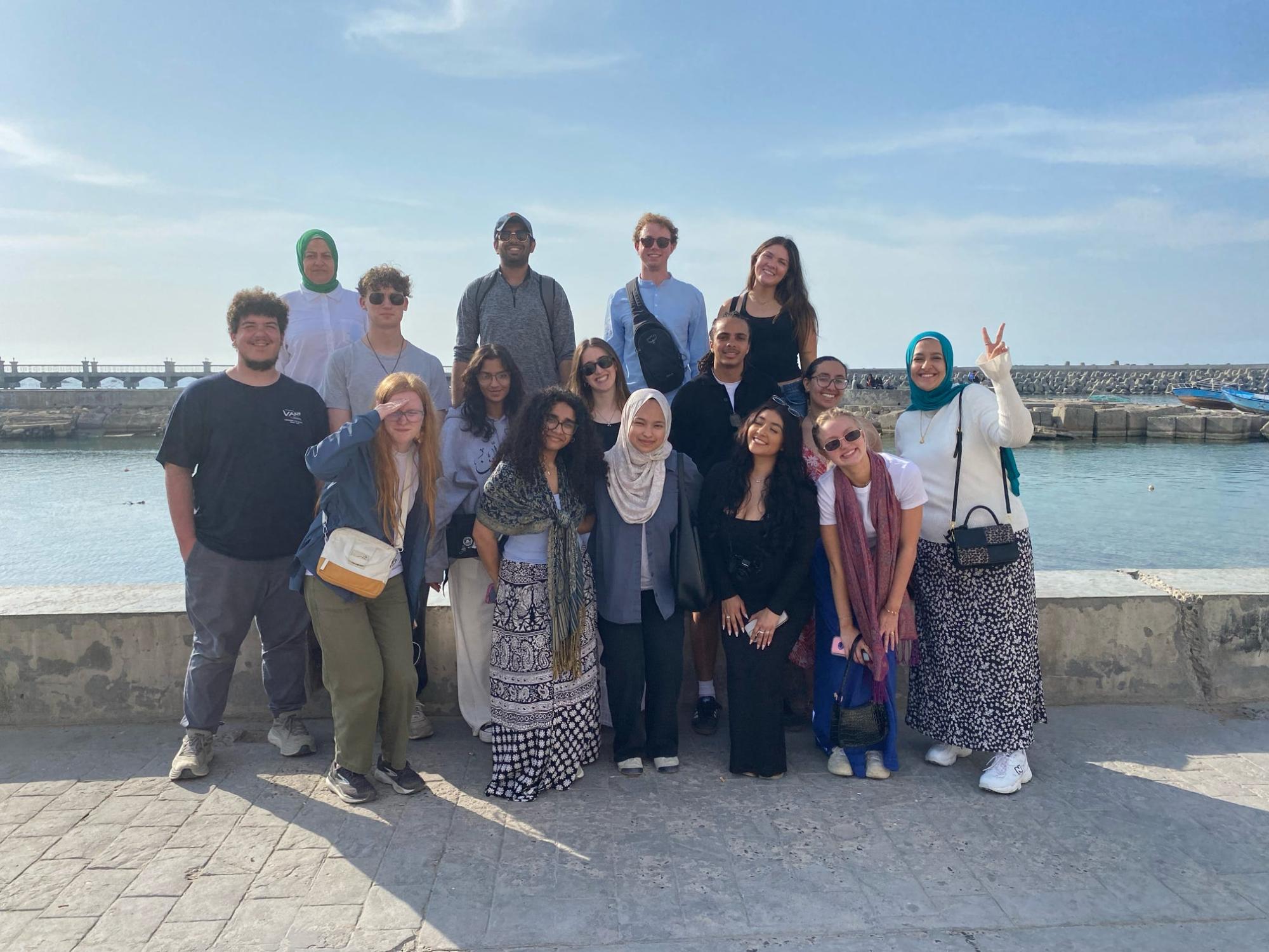 A group of students smiling in front of a river