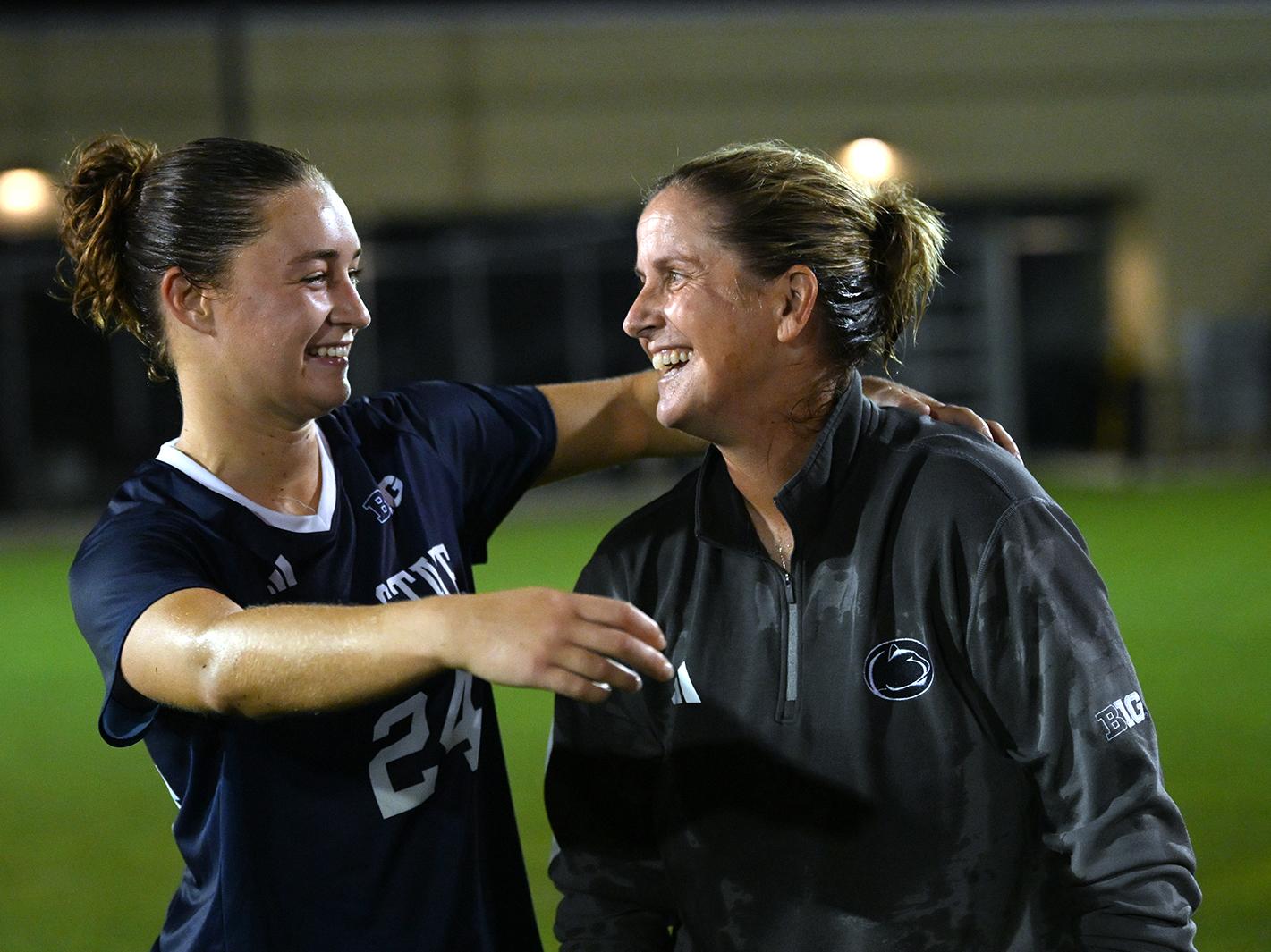 Soccer player hugs coach