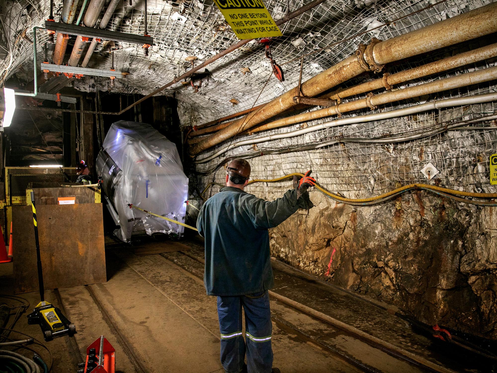 a person standing in a large underground tunnel