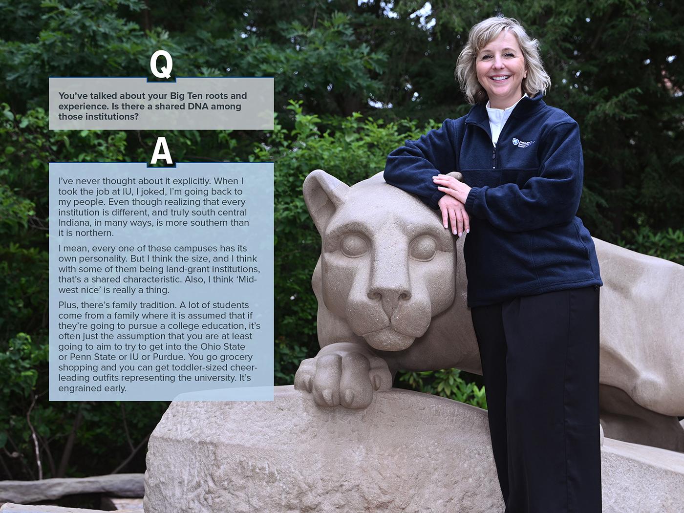 Woman in navy pullover standing at Nittany Lion shrine
