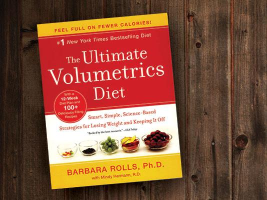 Barbara Rolls' book, The Ultimate Volumetrics Diet, is pictured on a wood grain background