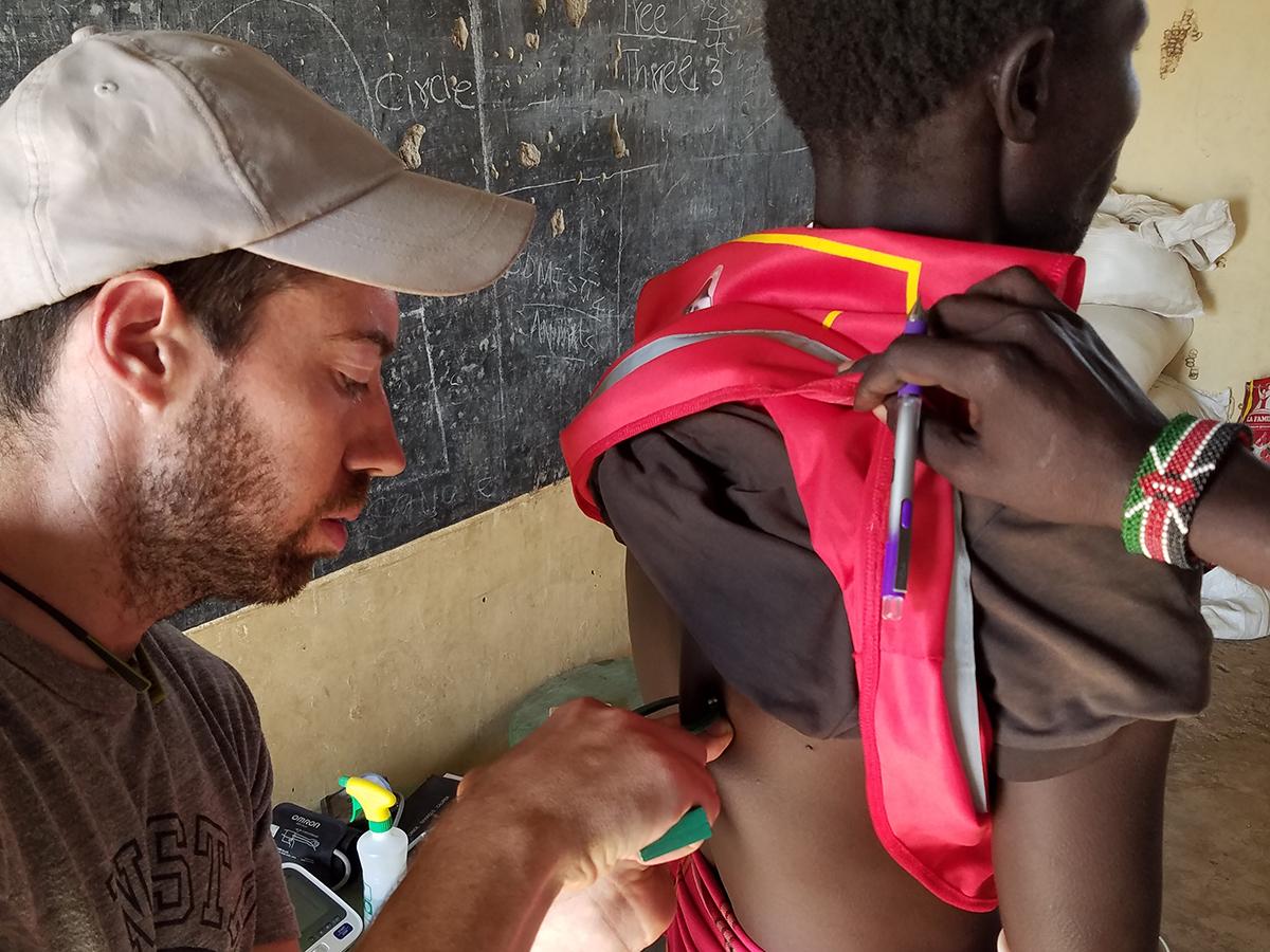 man uses measuring device on a study participant