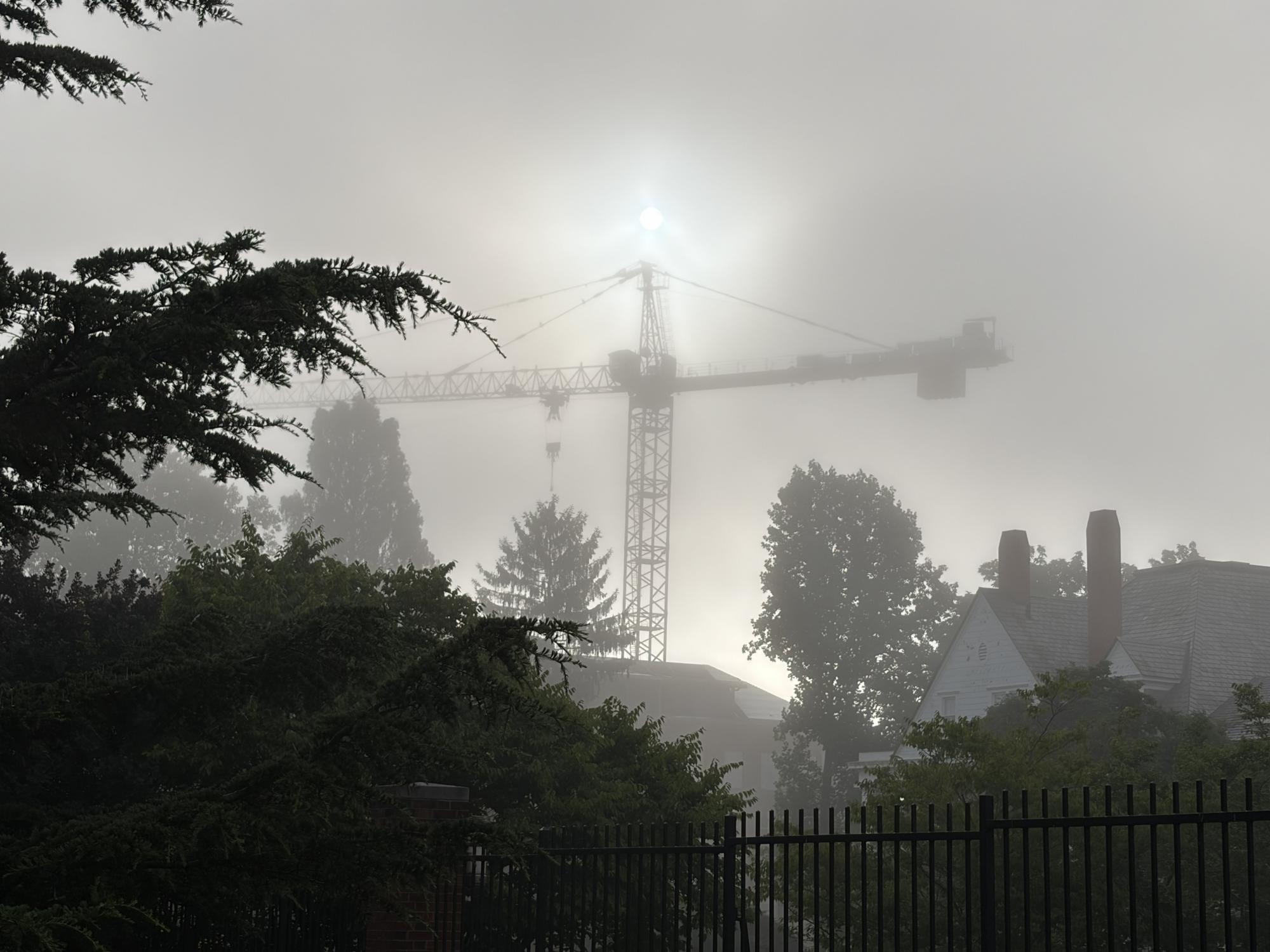 A picture of a crane tower in the fog