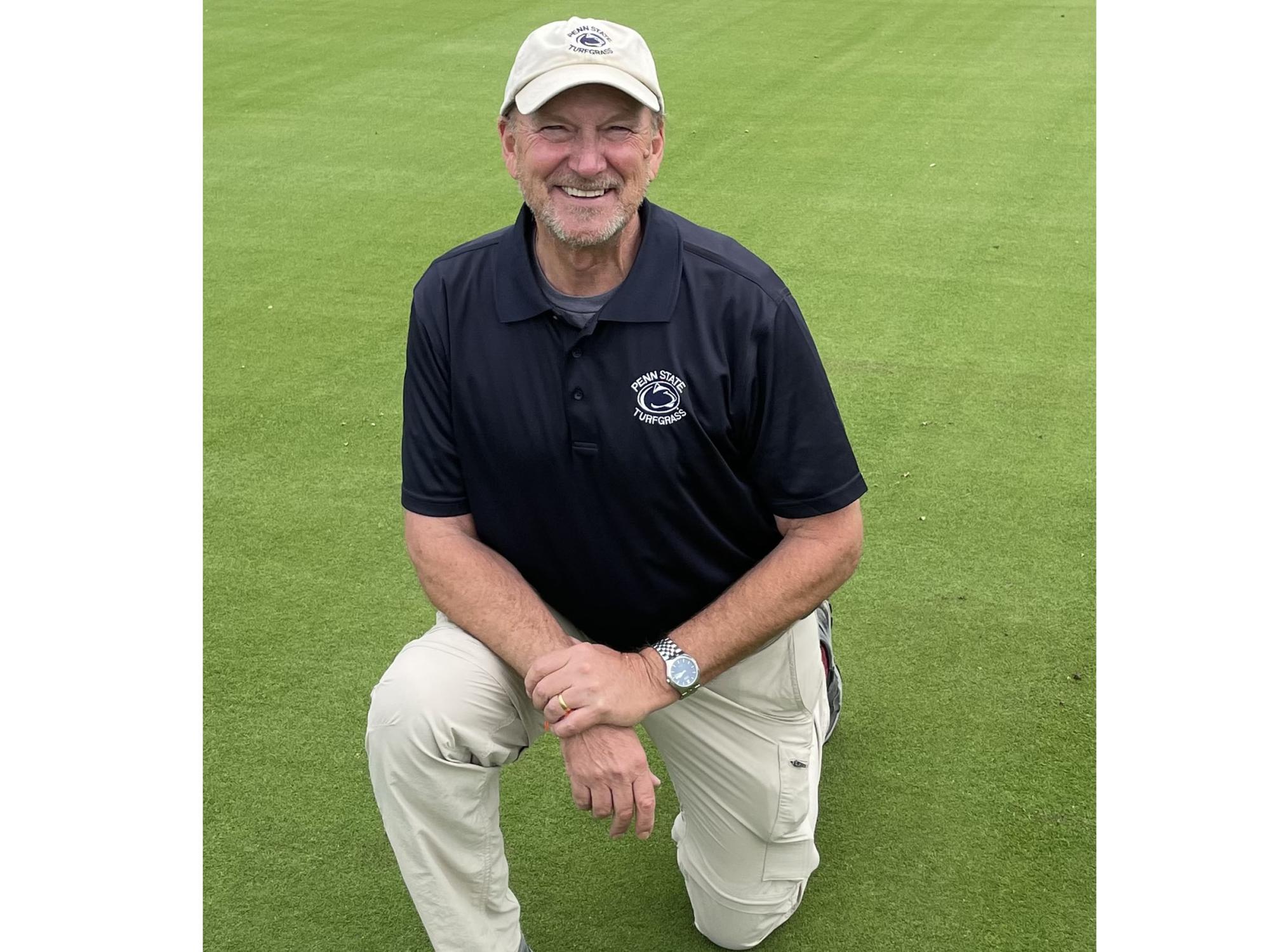 researcher stands on putting green