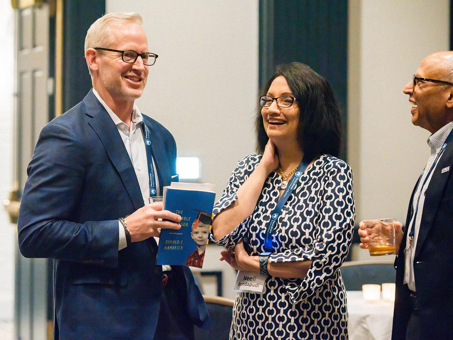 A photo of a smiling Corey Phelps and Neeli Bendapudi