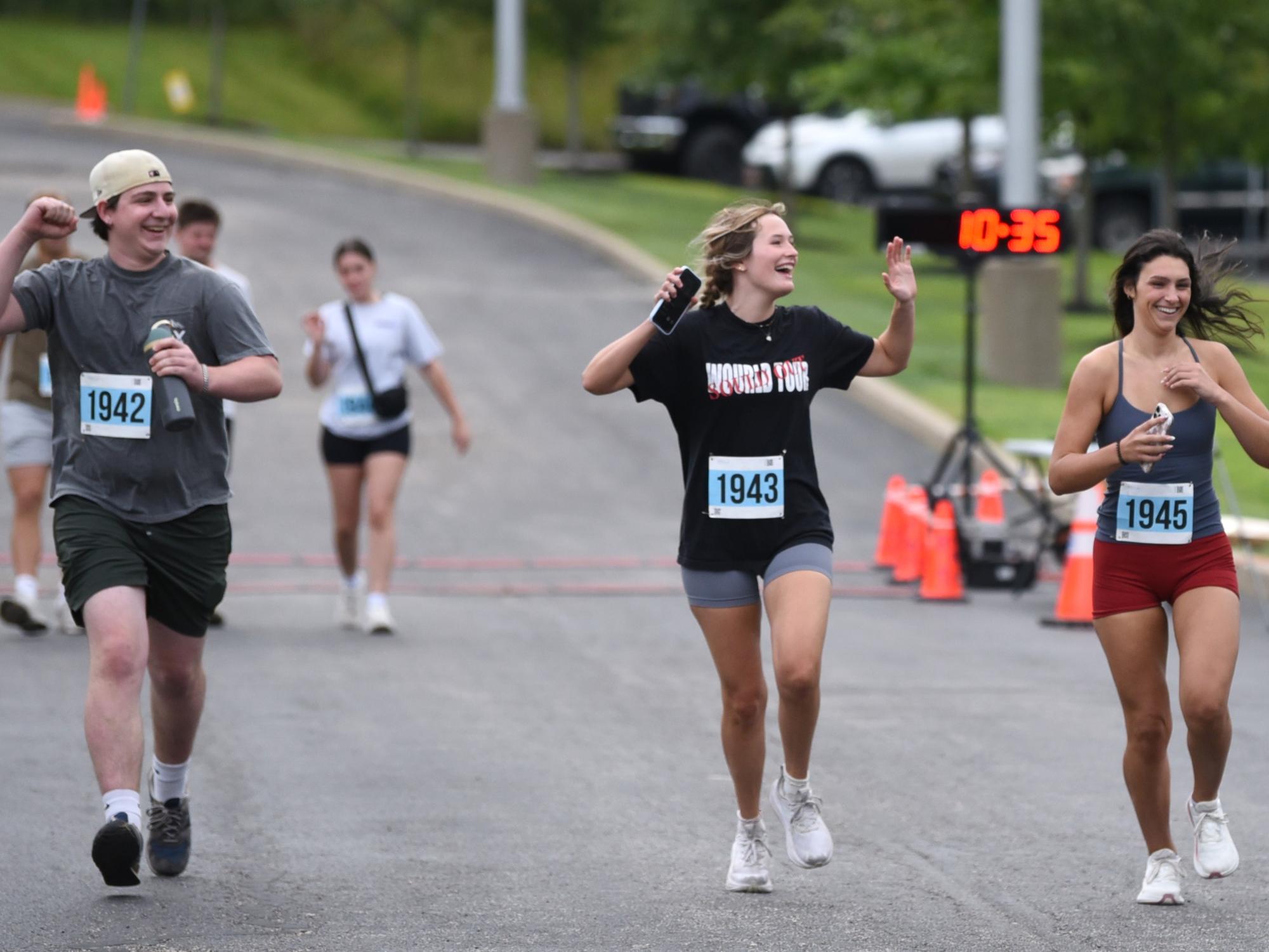 A male student and two female students begin the Run for Women 5K at Penn State Behrend.