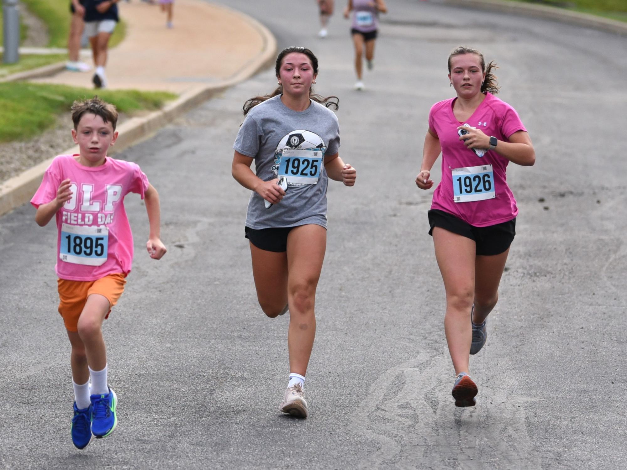Three young athletes compete in the Run for Women 5K at Penn State Behrend.