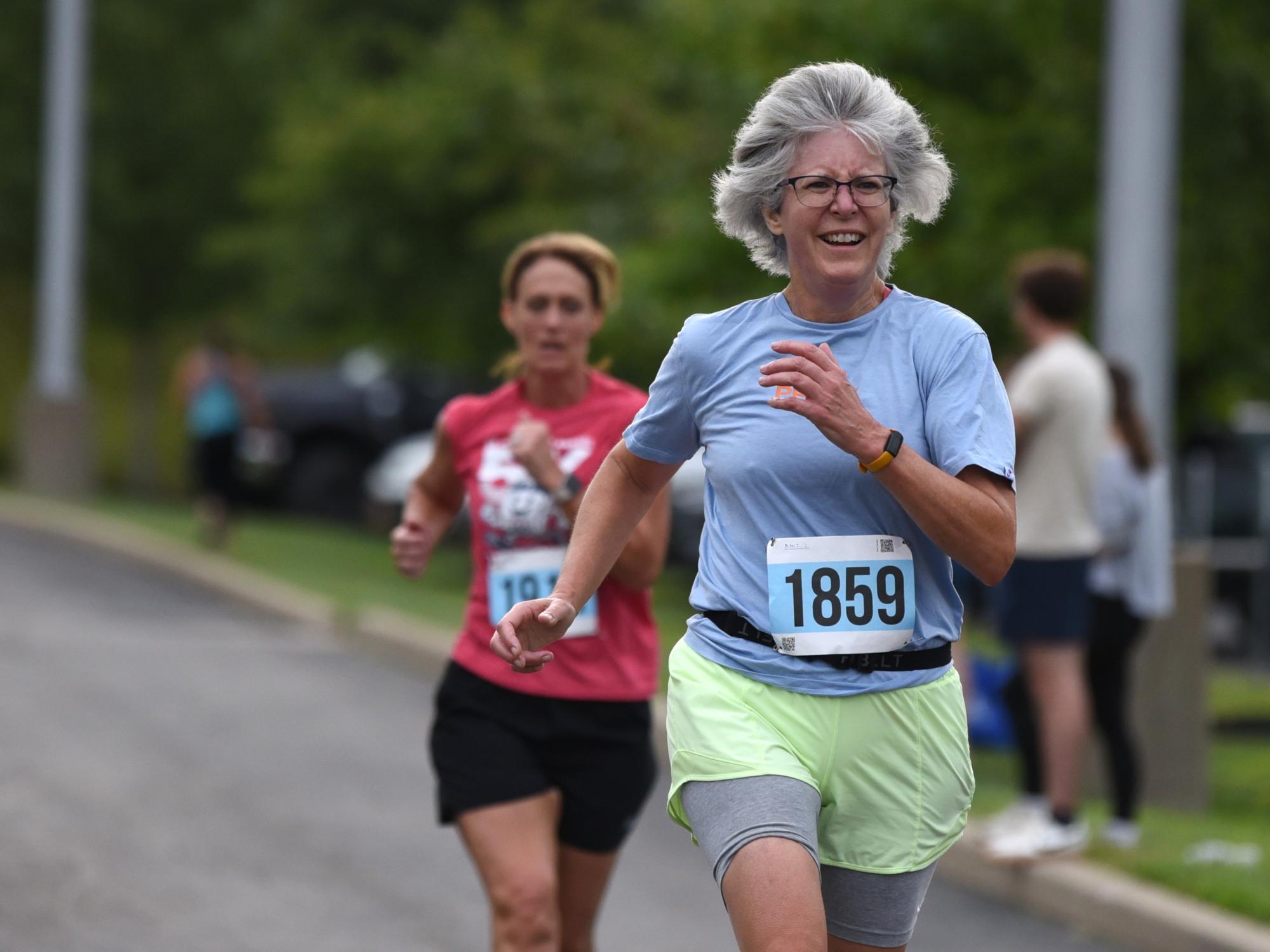Two women run during the Run for Women 5K at Penn State Brehrend