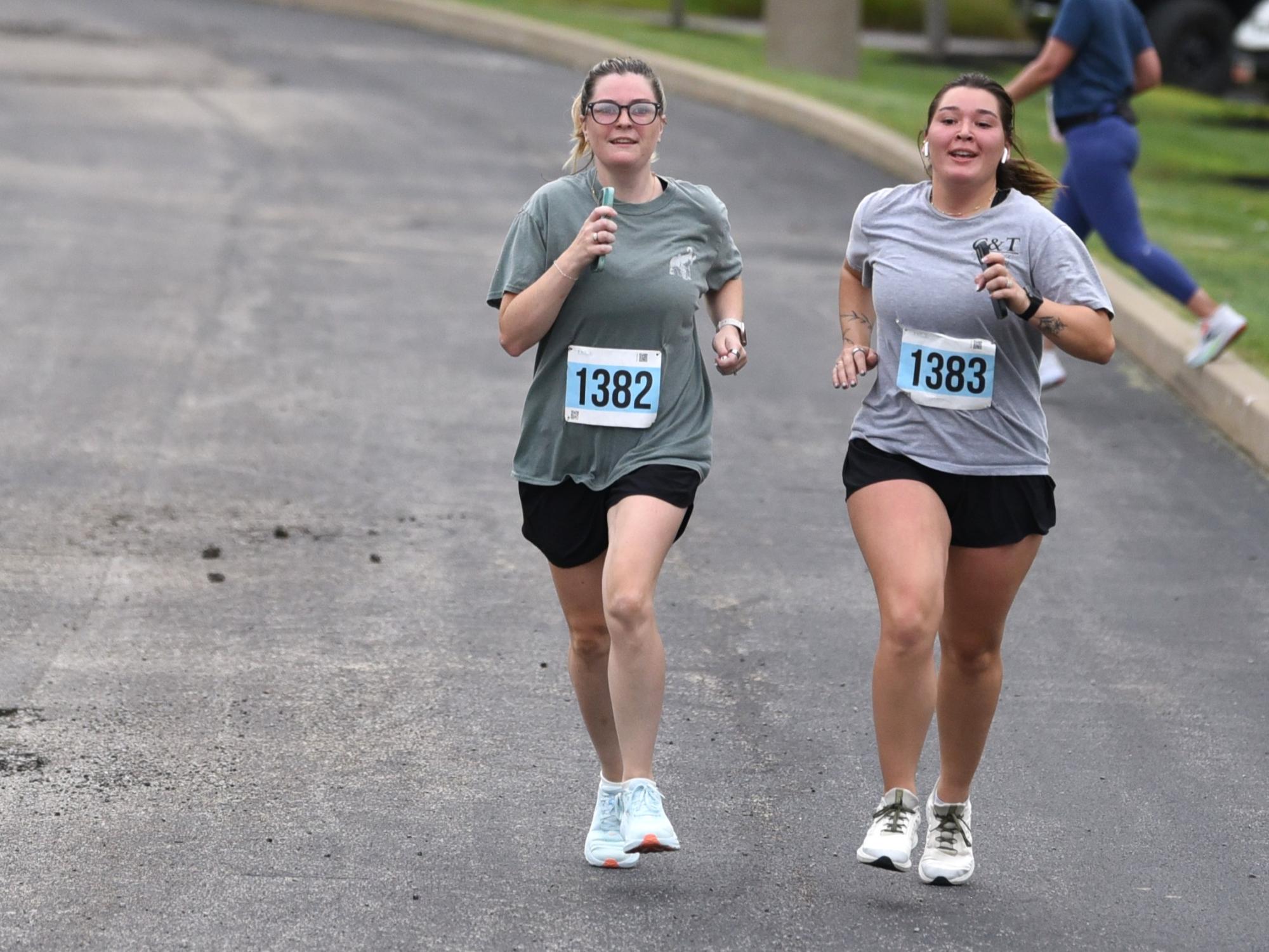 Two young women run together during the Run for Women at Penn State Behrend.