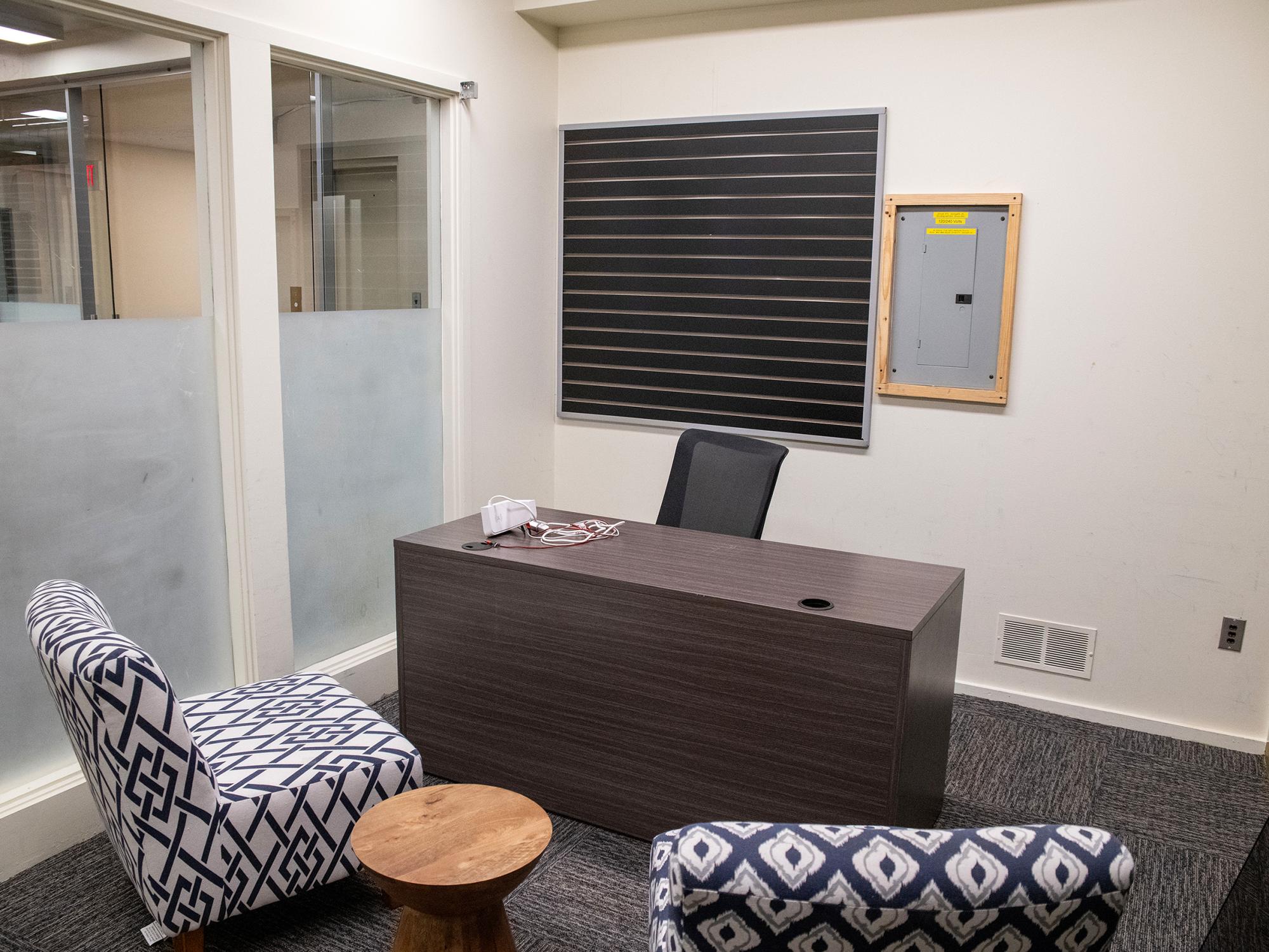 A private office in the Mon Valley LaunchBox features a desk, guest seating, glass partitions, and flexible workspace furnishings.