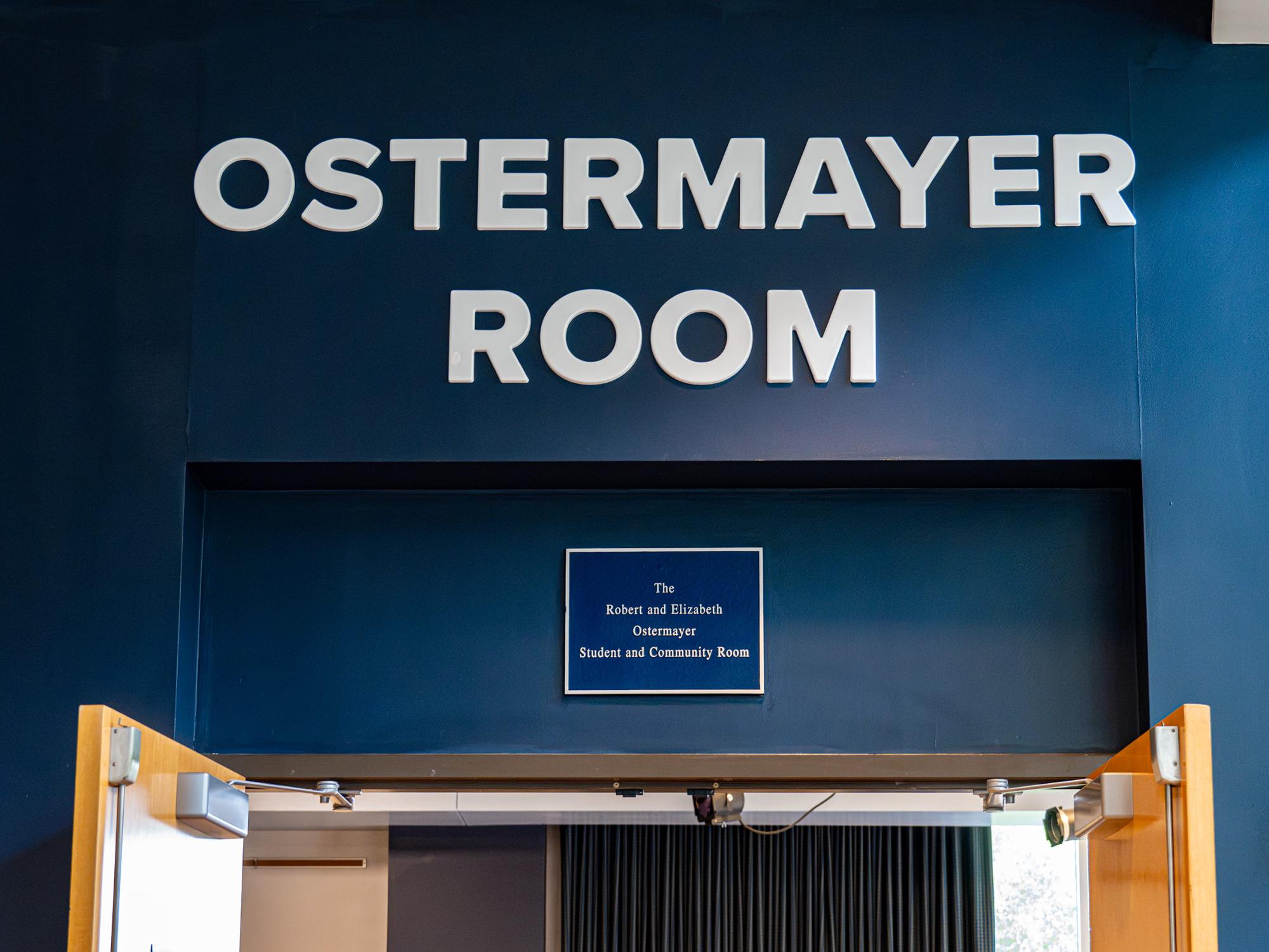 Entrance to the Ostermayer Room featuring updated signage above the doorway and a commemorative plaque honoring Robert and Elizabeth Ostermayer.