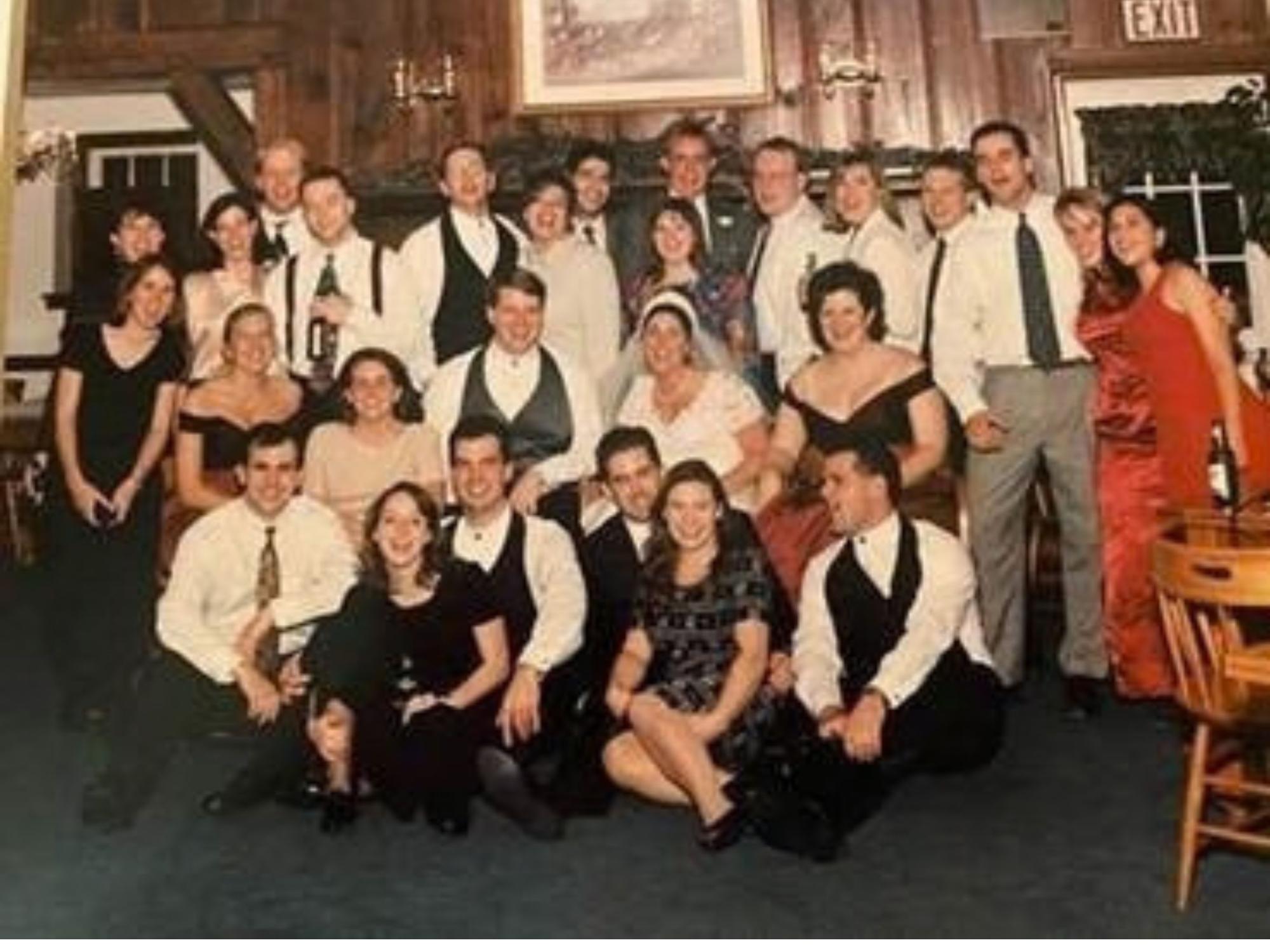 large group of wedding reception guests in formal attire