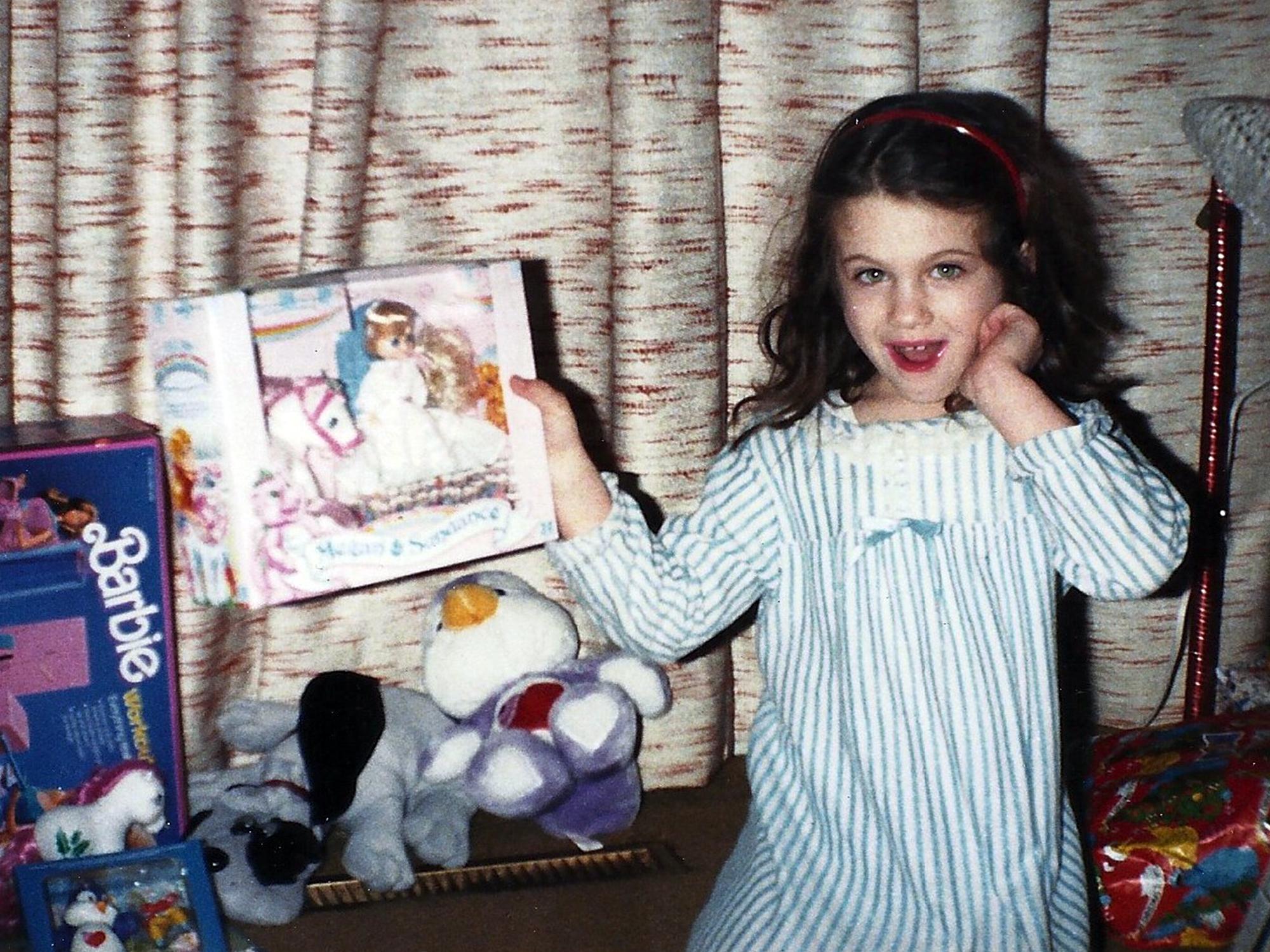 Child holds up a toy 