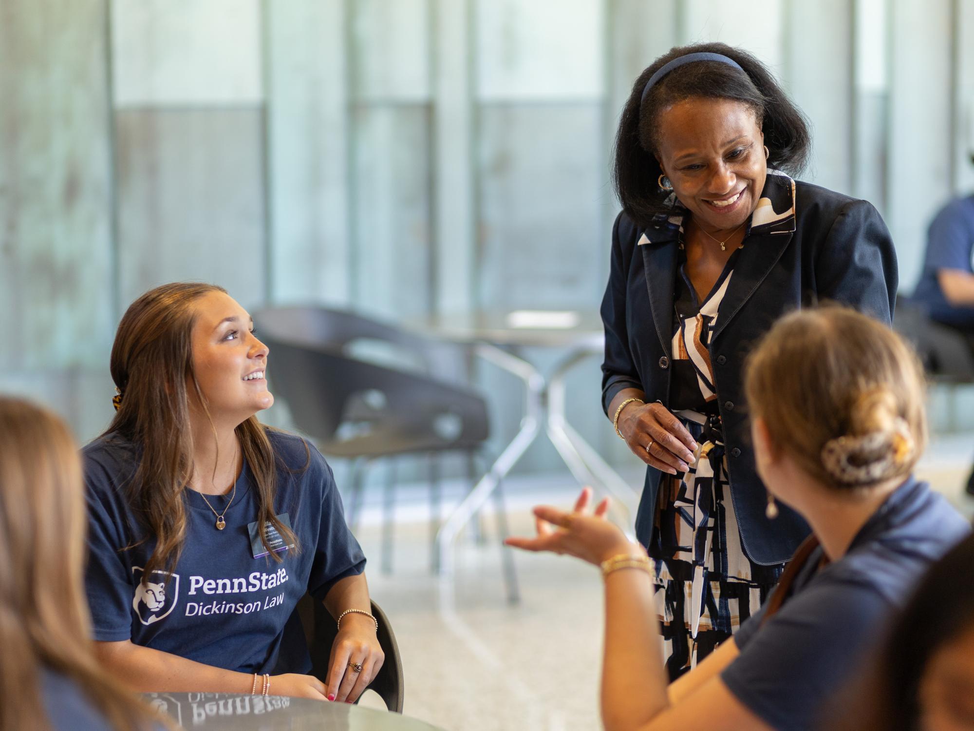 Black woman talking with several students