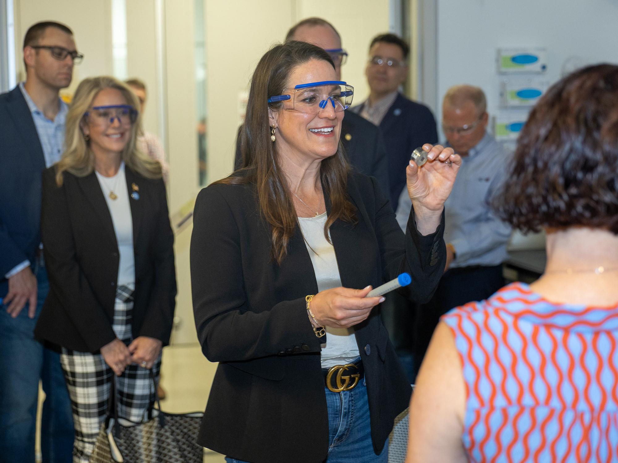 A woman meets with a scientist to examine a sample that's fed into a materials characterization tool