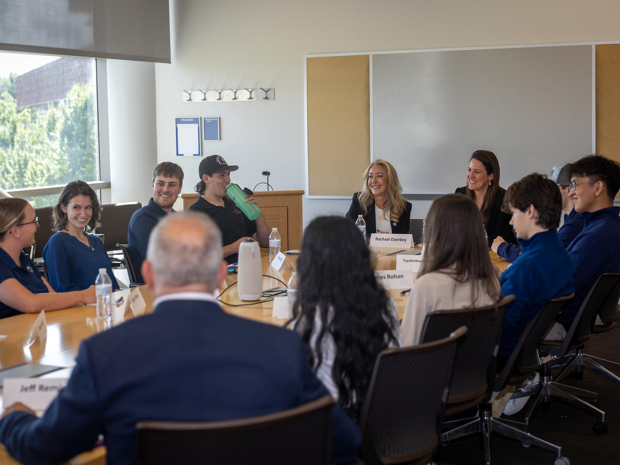 Two professionals meet with students who are interested in careers in mining engineering or related fields