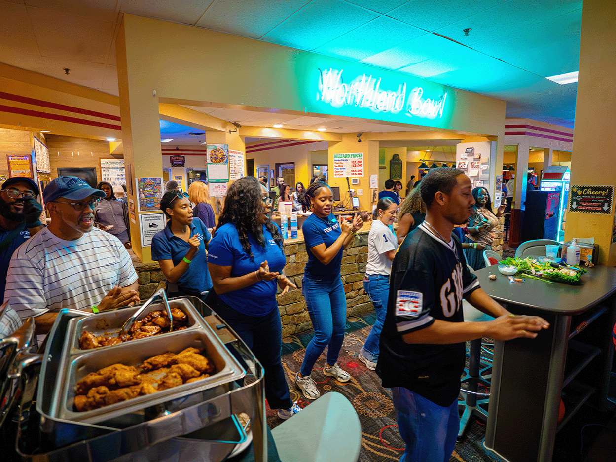 Penn State students and staff dancing at a bowling alley