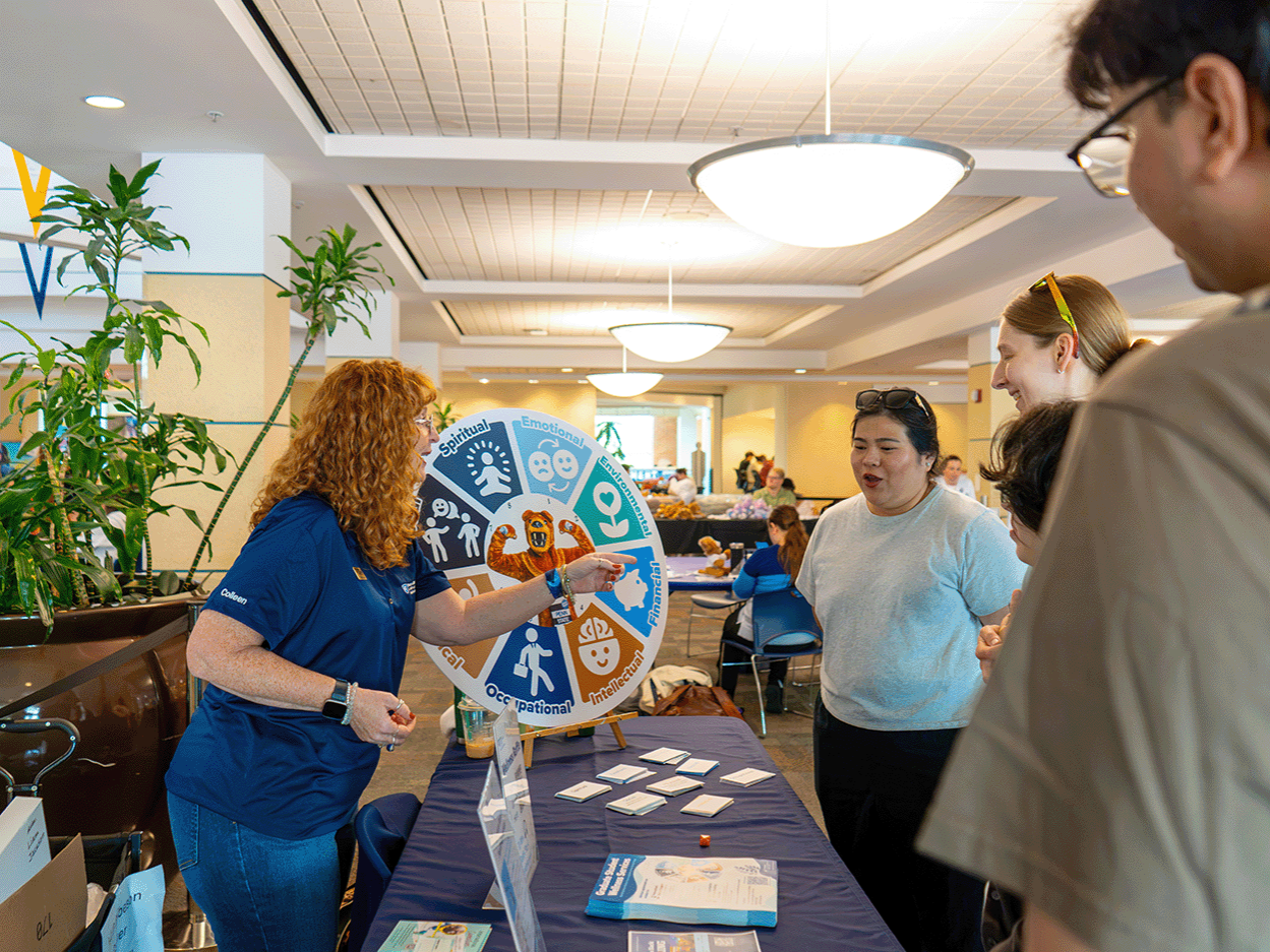 Colleen Lanzoni, associate director of graduate student wellness, leads graduate students through an engaging wellness activity