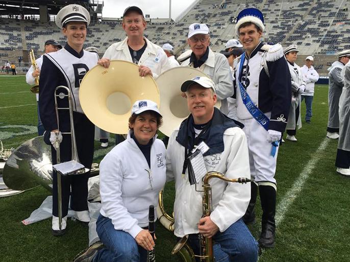 An image of six people posing on the Beaver Stadium football field