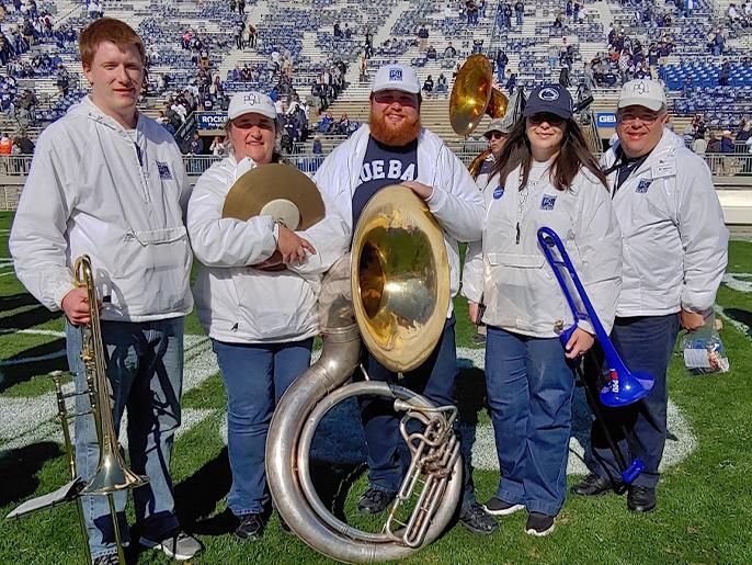 An image of five people on the field at Beaver Stadium