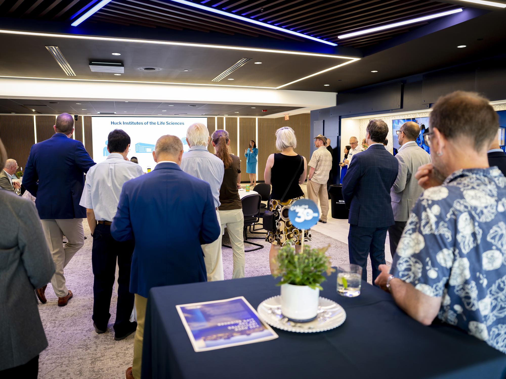 Attendees watch Christina Grozinger, Publius Vergilius Maro Professor of Entomology and director of the Huck Institutes of the Life Sciences, speaking at the Huck Institutes 30th Anniversary Event. August 28, 2026