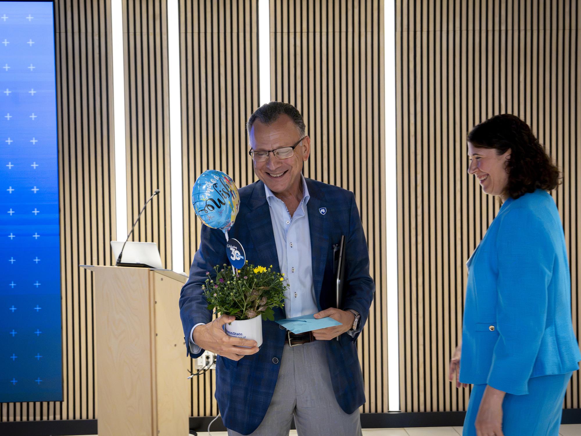 Penn State Provost Fotis Sotiropoulos receiving a birthday message from Huck Institutes Director Christina Grozinger at the Huck Institutes 30th Anniversary Event. August 28, 2026