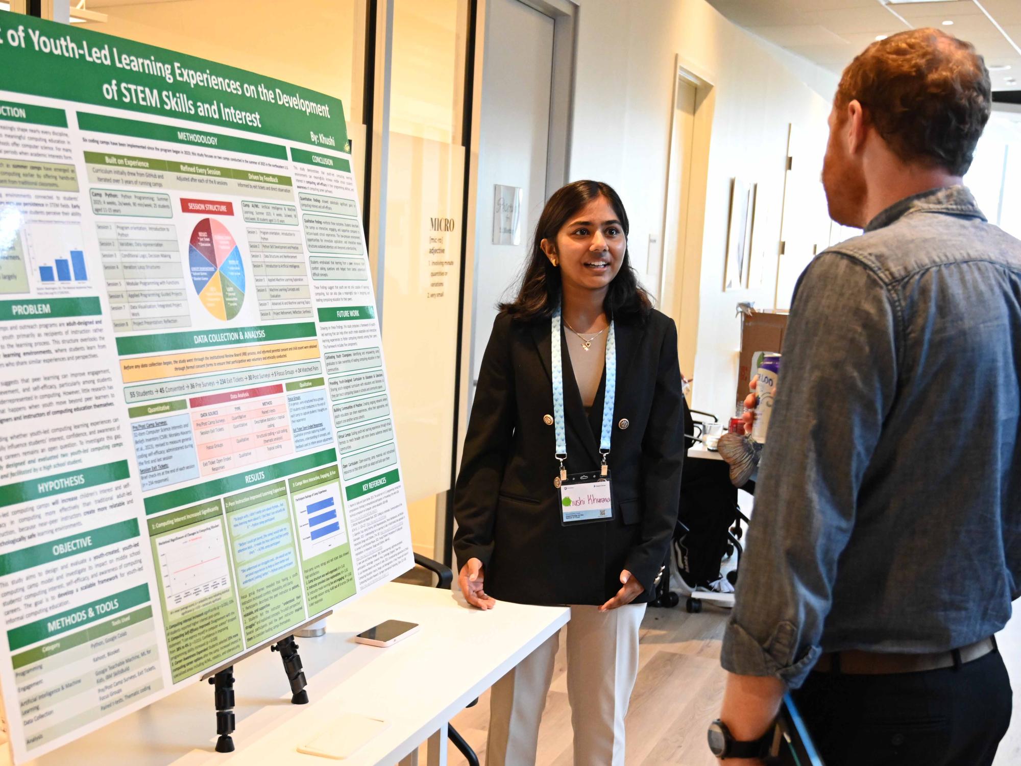 Student Khushi Khurana sharing her project with a conference attendee.